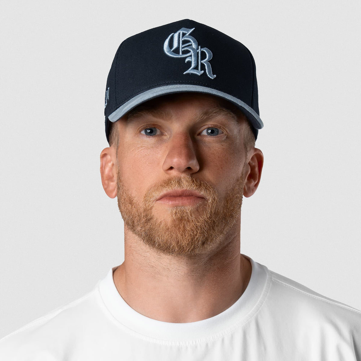 Male model wearing the 5-Panel Initial Suede Hat - Blue front view