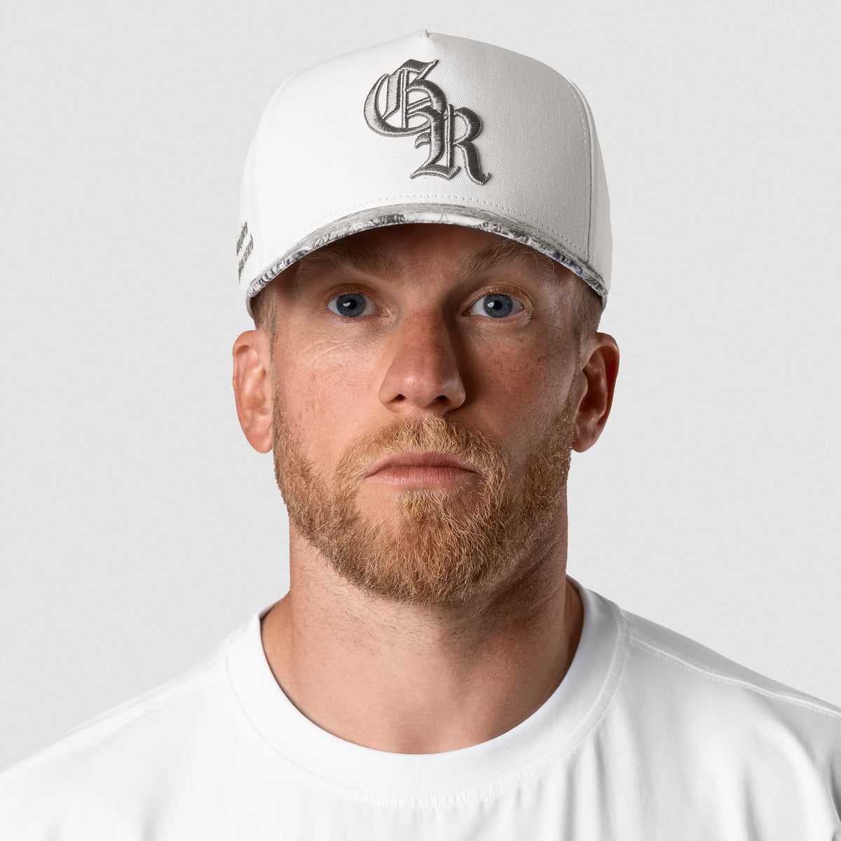 Male model wearing the 5-Panel Initial Hat - White Camo front view