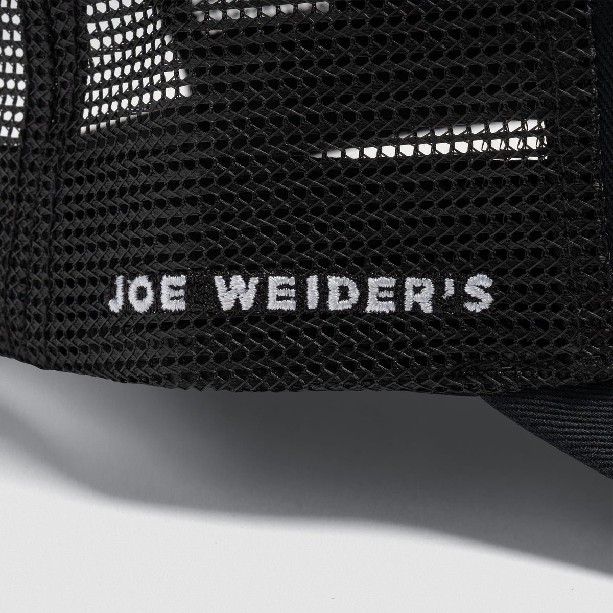 Side stitched text "Joe Weirders" on the mesh material of the Signature 5-Panel Trucker Hat