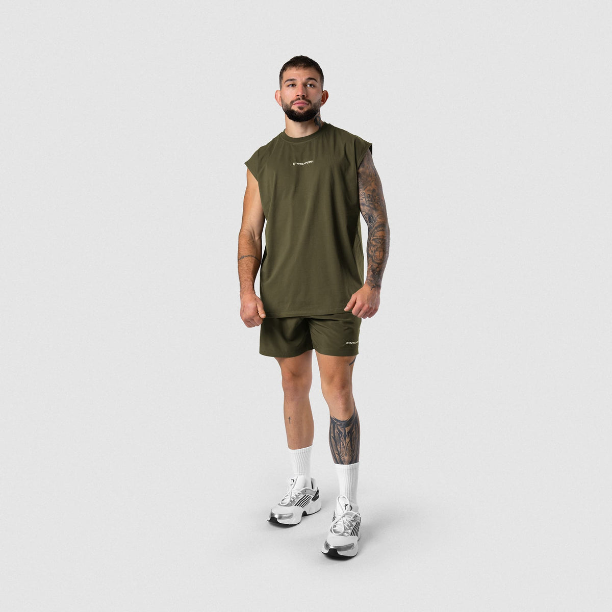 Male model wearing the Axis 6" Lined Shorts - OD Green full-body view