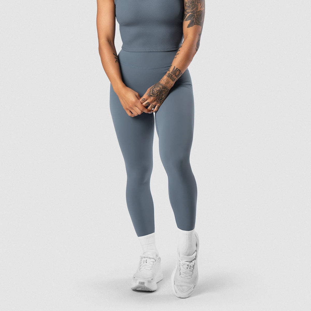 Female model wearing the Axis Leggings - Lake front lower-body view