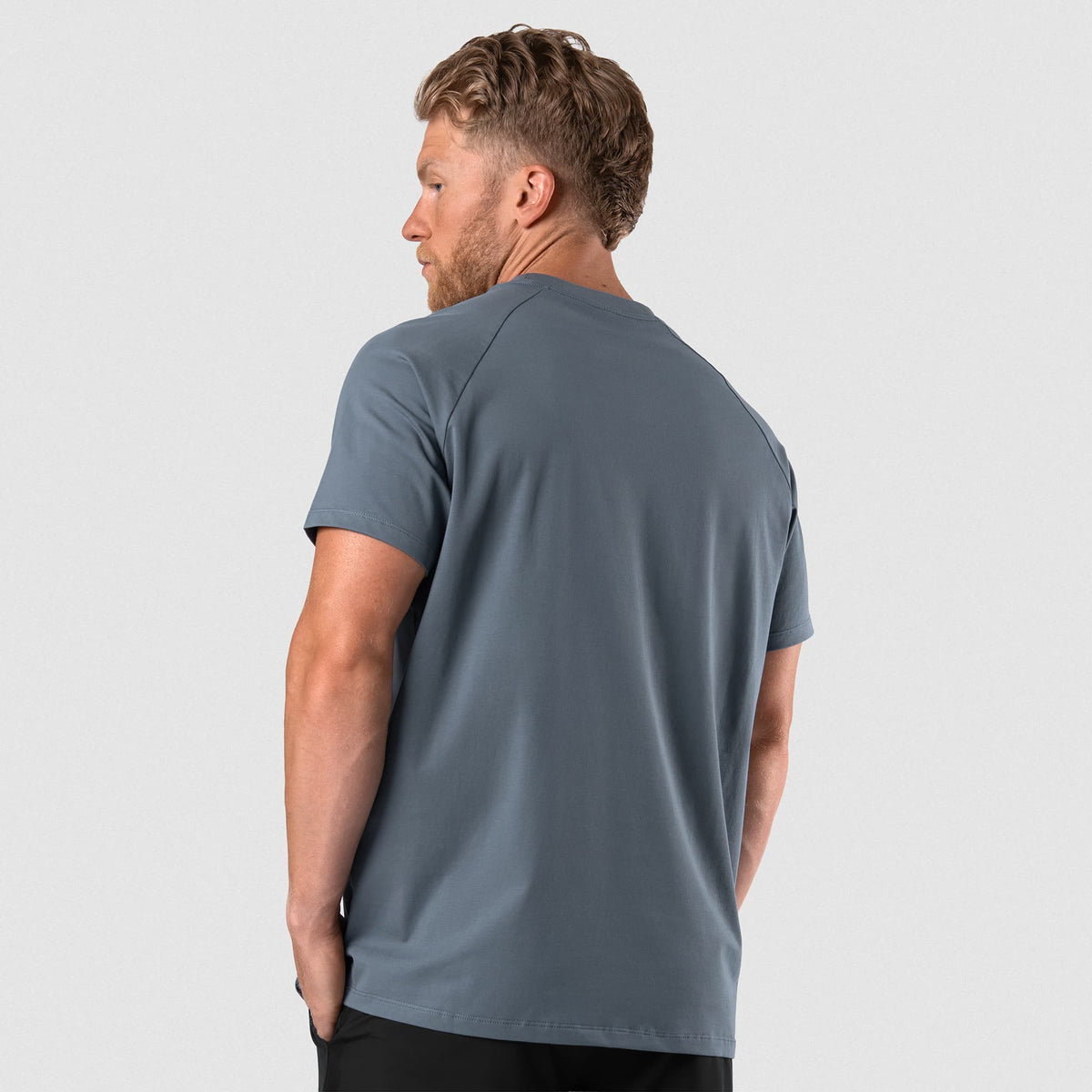 Male model wearing the Axis Raglan Tee - Lake back view