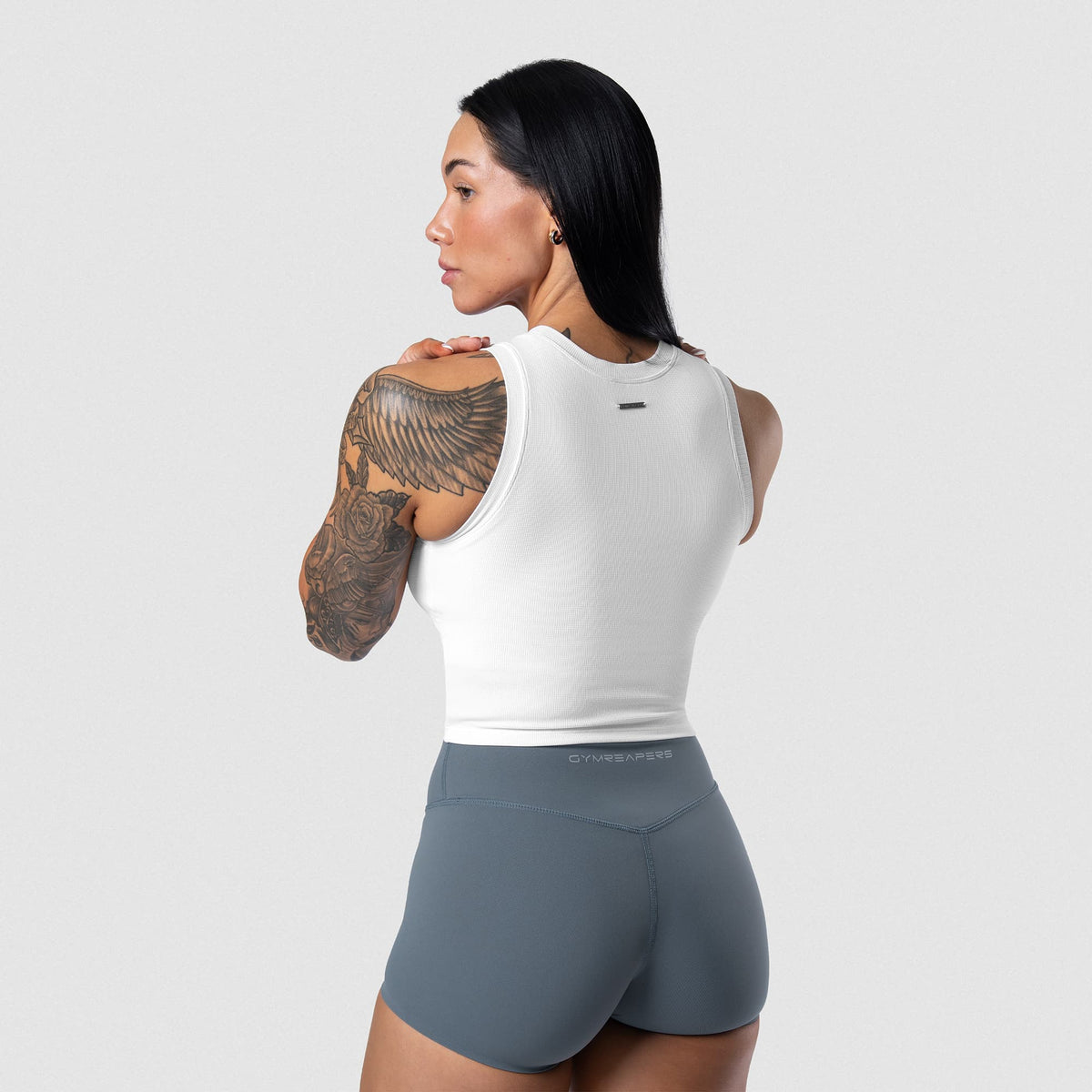 Female model wearing the Axis Support Tank - White side view