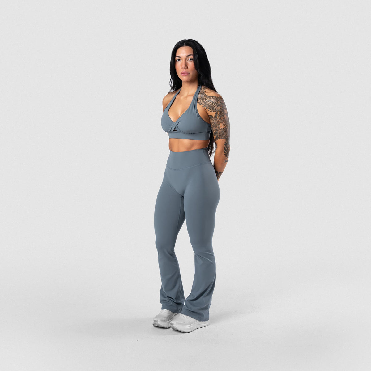 Female model wearing the Axis Twisted Halter Bra - Lake full-body view