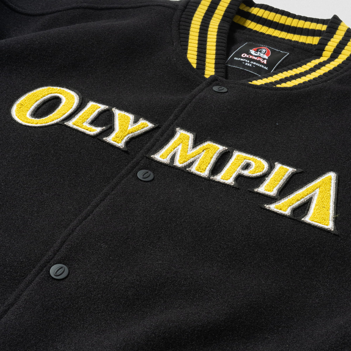 Olympia Champions Gold Varsity Jacket in Black – Collar and "OLYMPIA" Trim Detail