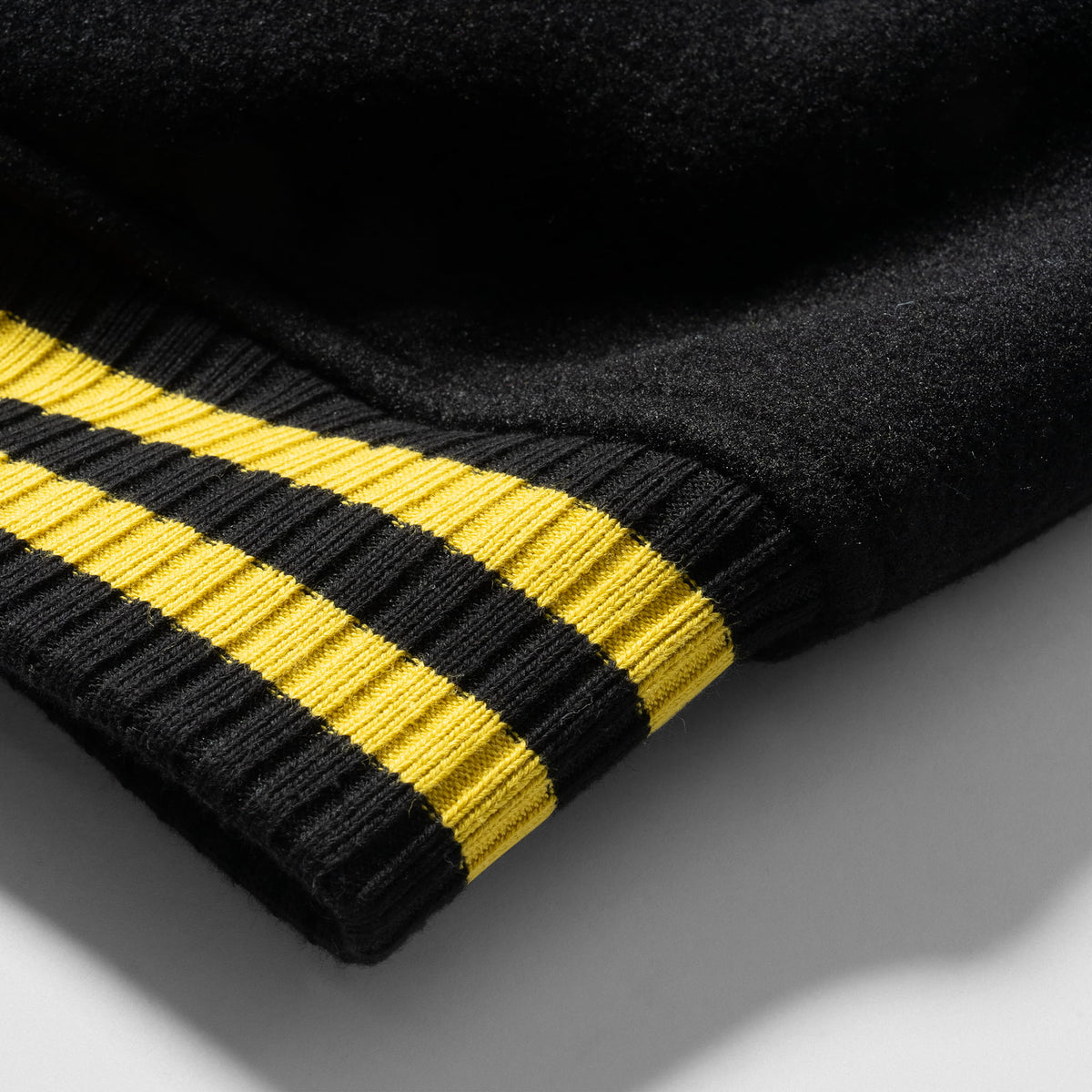 Olympia Champions Gold Varsity Jacket in Black – Ribbed Cuff Striped Trim Detail