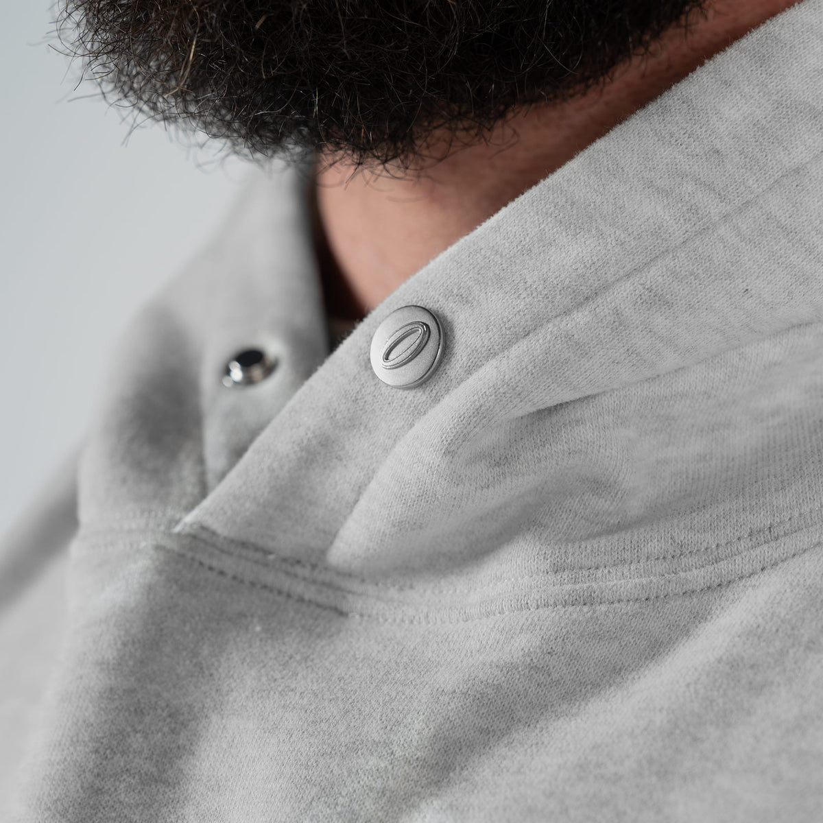 International Division Hoodie | drawcord-free hood with silver snap-button closure feature