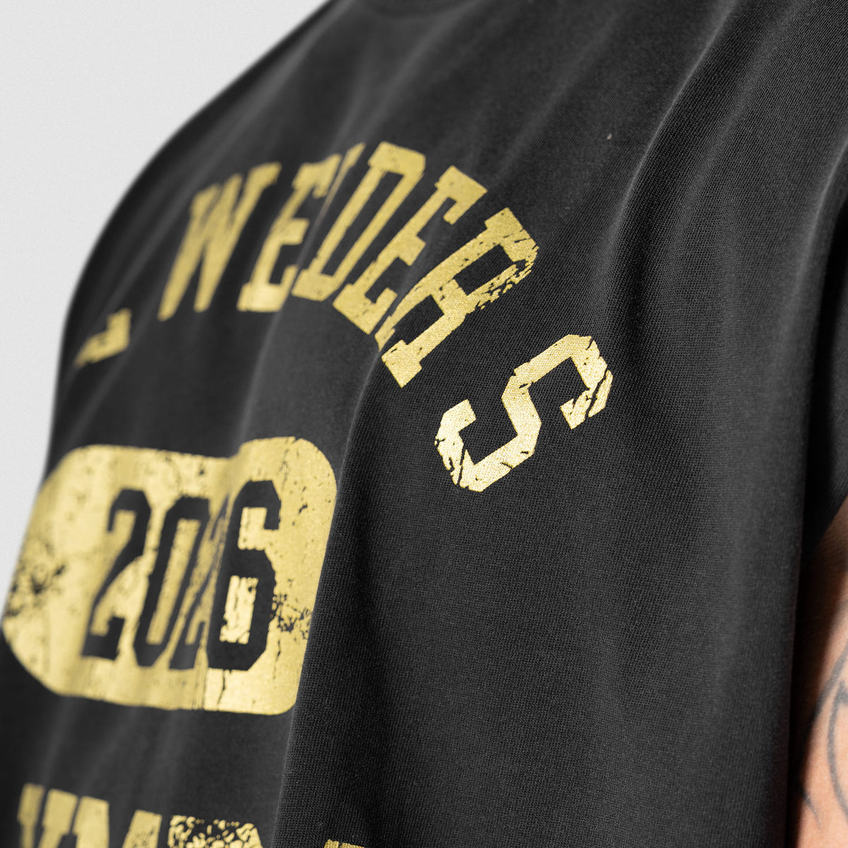 Close up side view of the front logo on the Joe's Cut Off tank top
