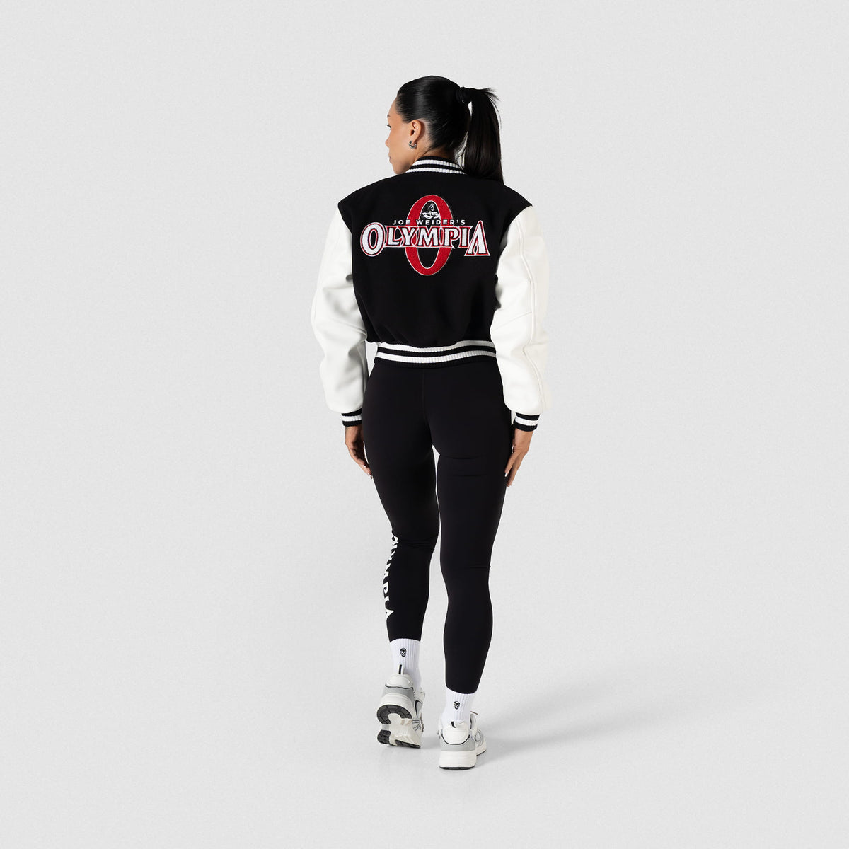 Signature Crop Varsity Jacket | Full body, on model back view with matching leggings