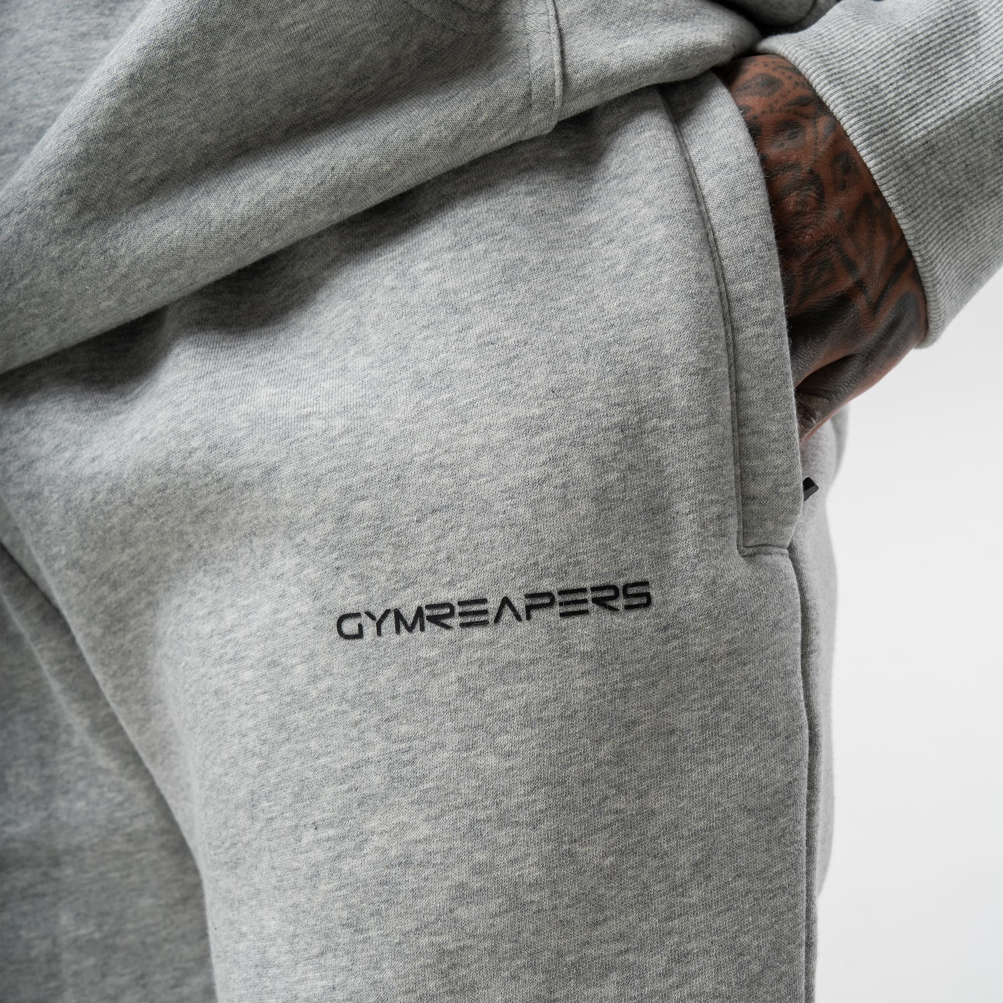 athlete wearing gray axis joggers close up detail shot of logo