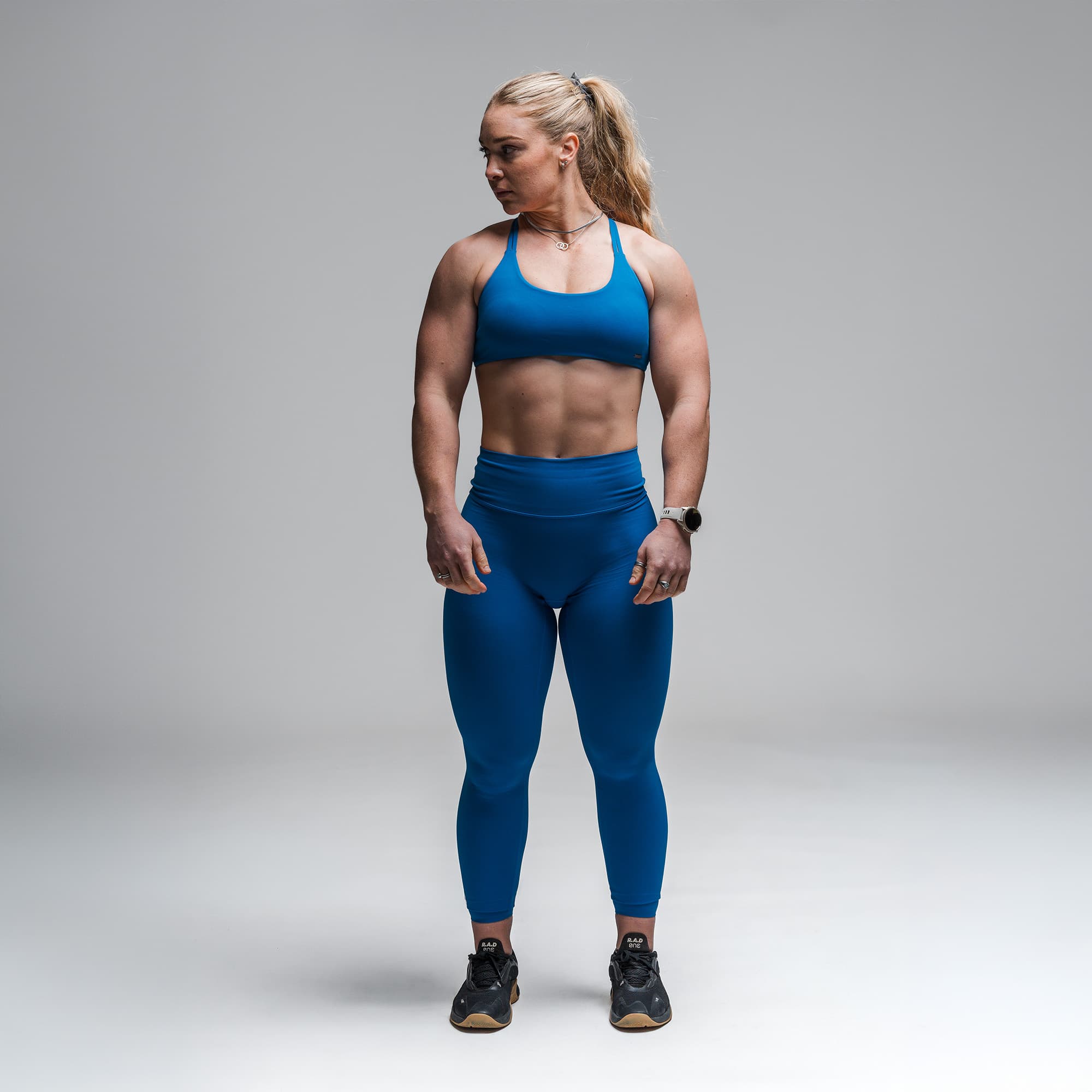 Athlete wearing the Electric Blue Axis Open Back Bra full body shot front view