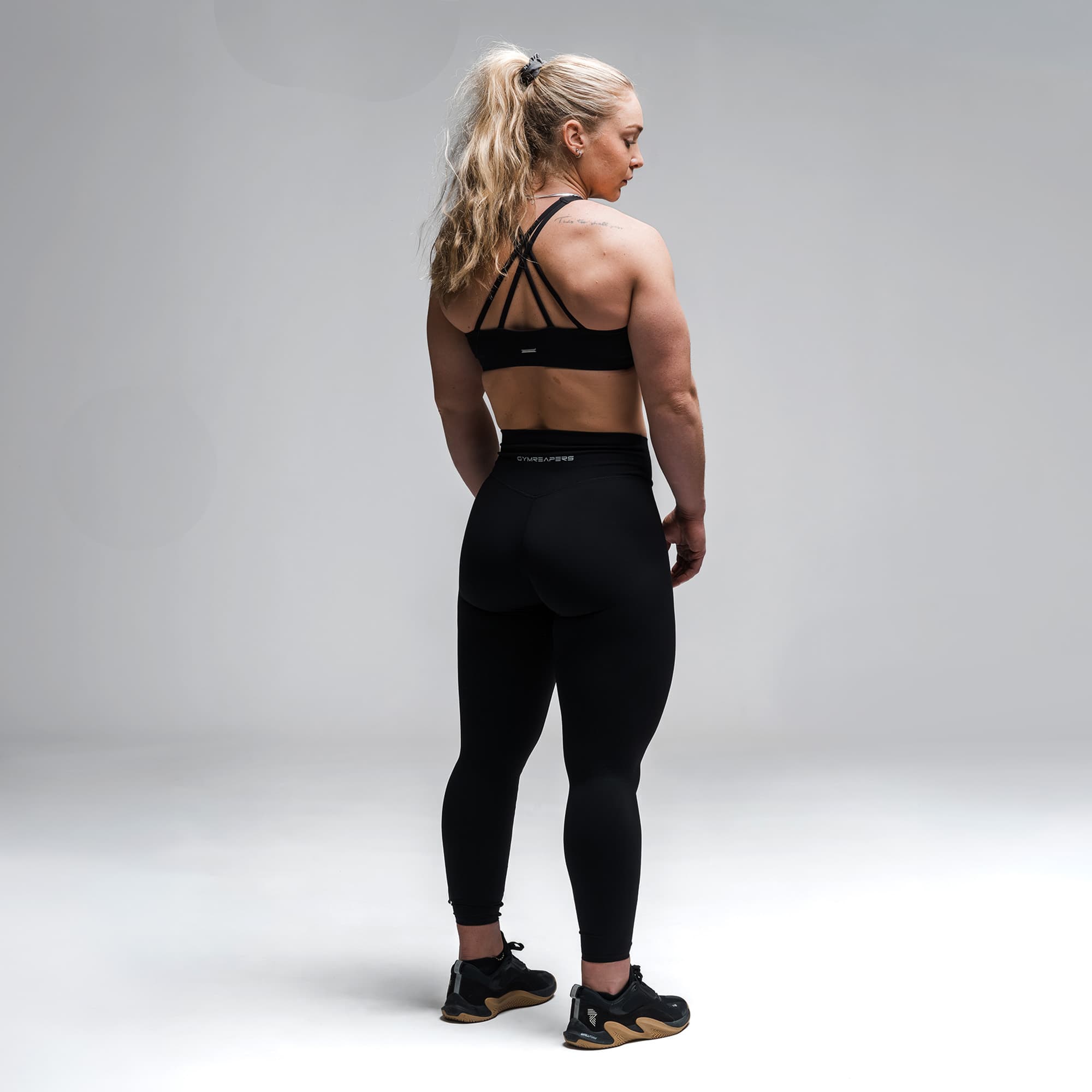 Athlete wearing the Black Axis High Neck Bra full body shot back view