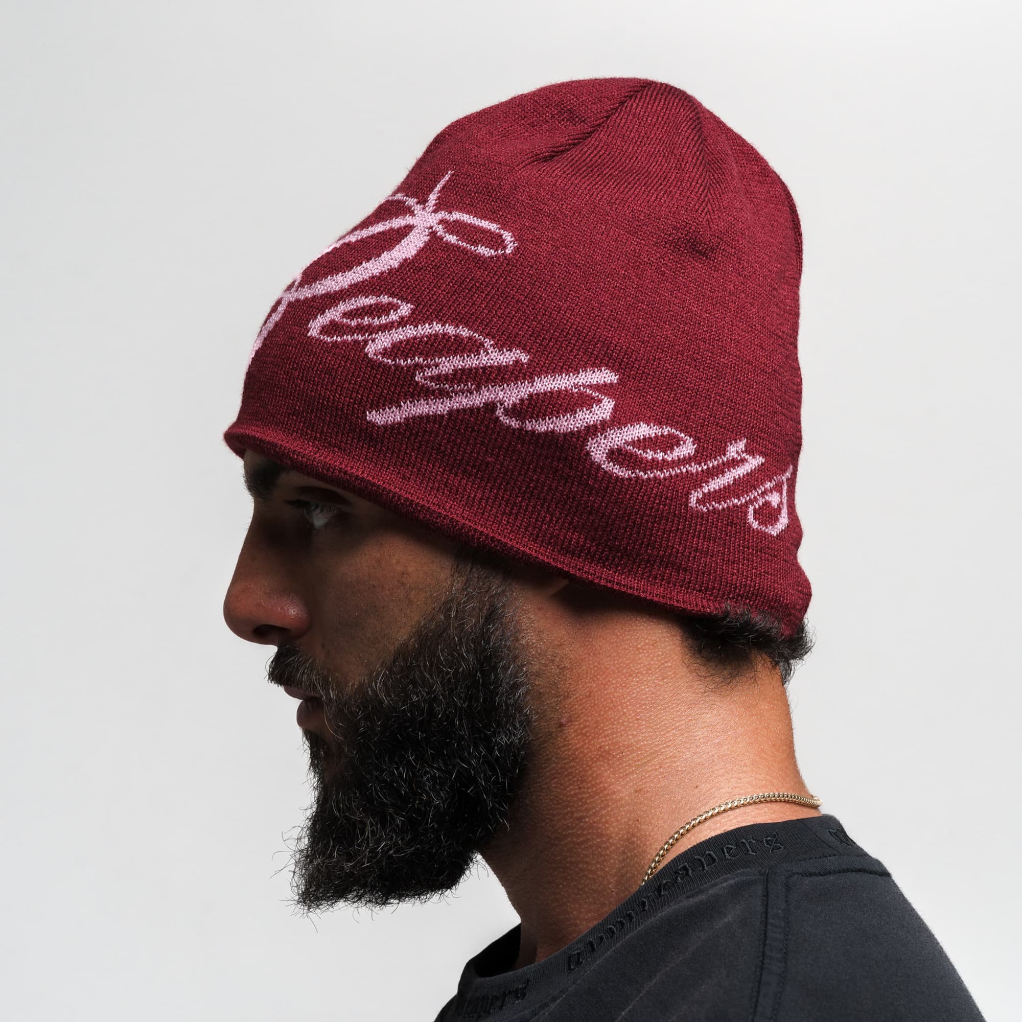 Athlete wearing Reapers Skull Cap Beanie - Maroon/Pink side view