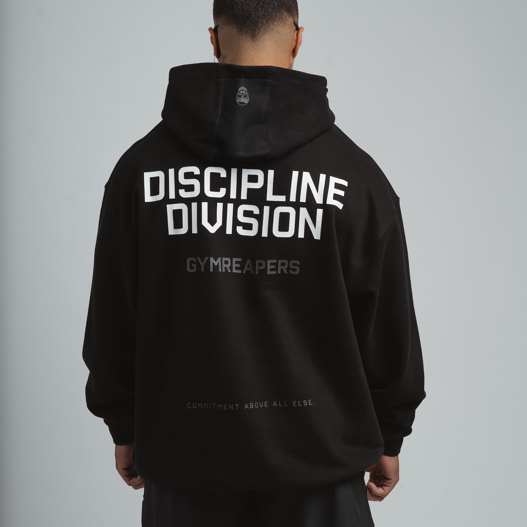 discipline division man wearing hoodie full back view