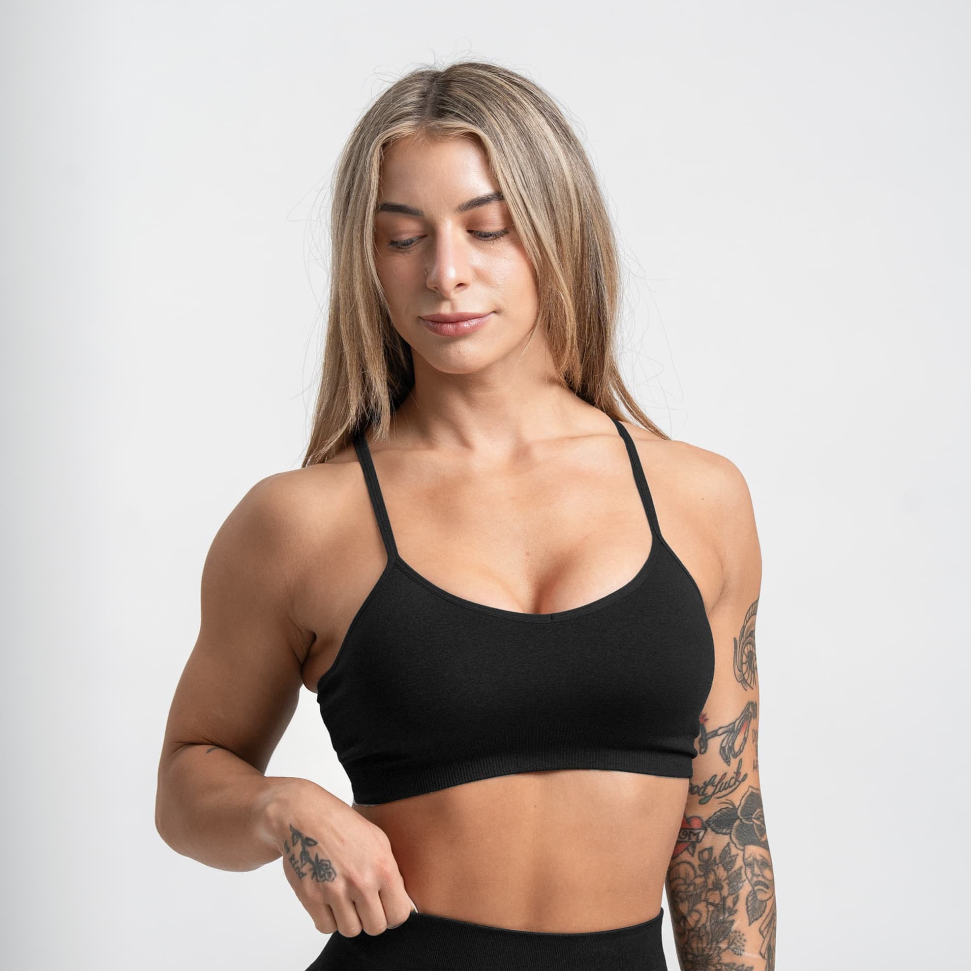 athlete wearing the black infinity bra half body shot front view