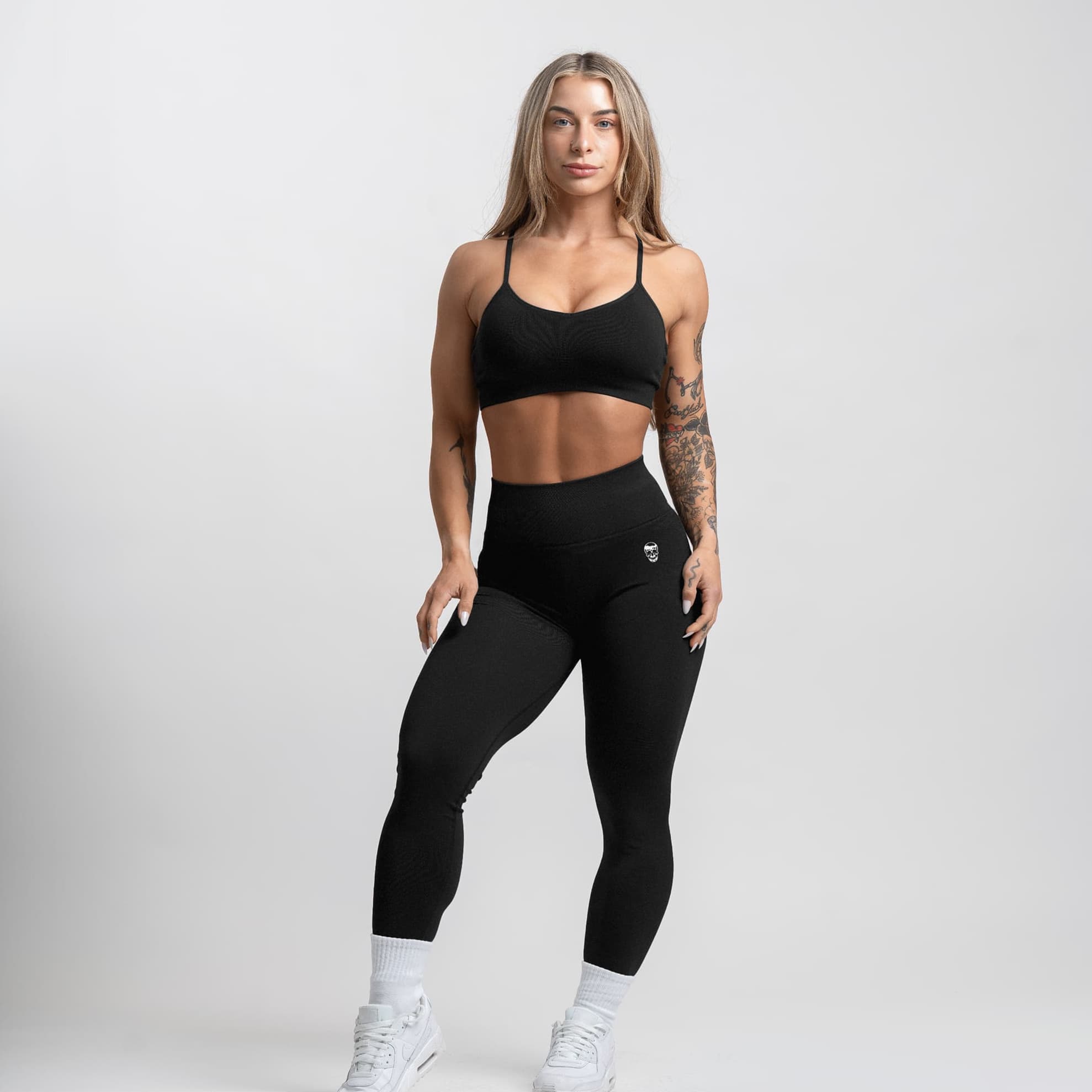 athlete wearing the black infinity bra full body shot front view