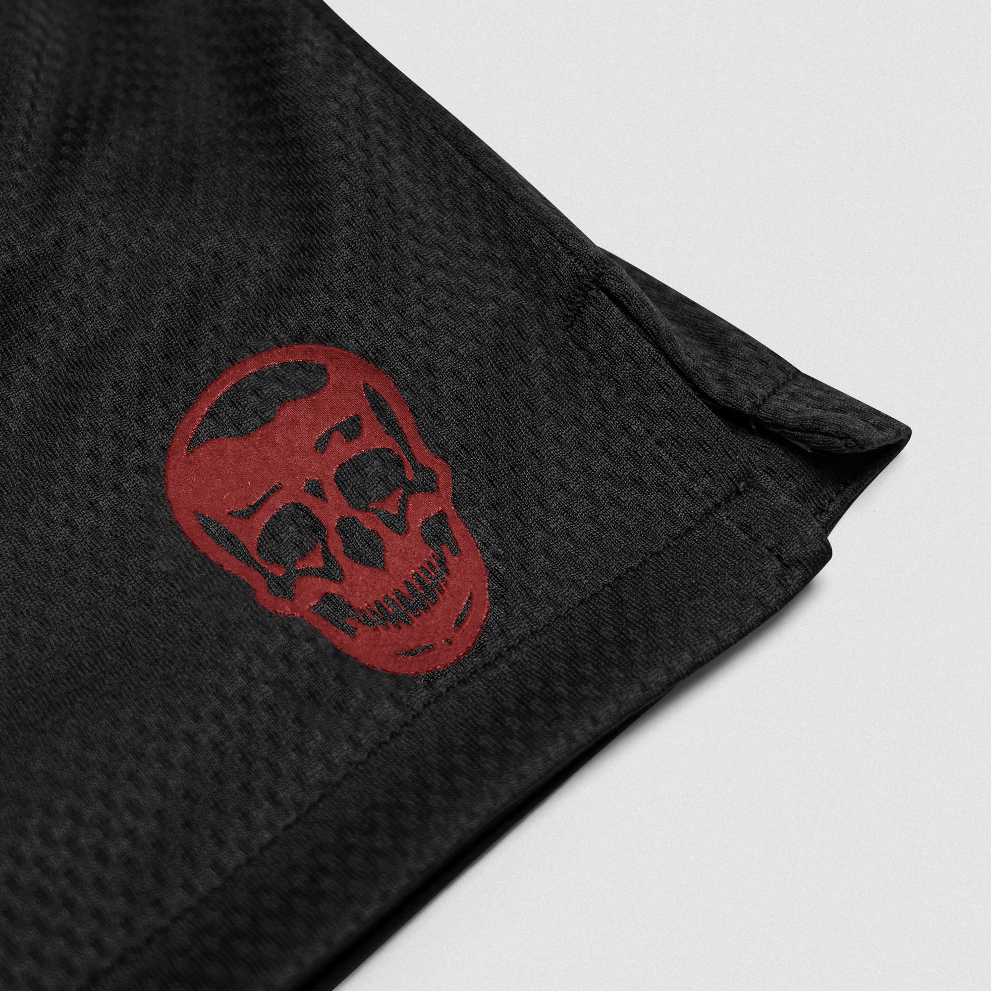 Black/Red Core Skull Mesh Training Shorts lay flat detail shot of logo