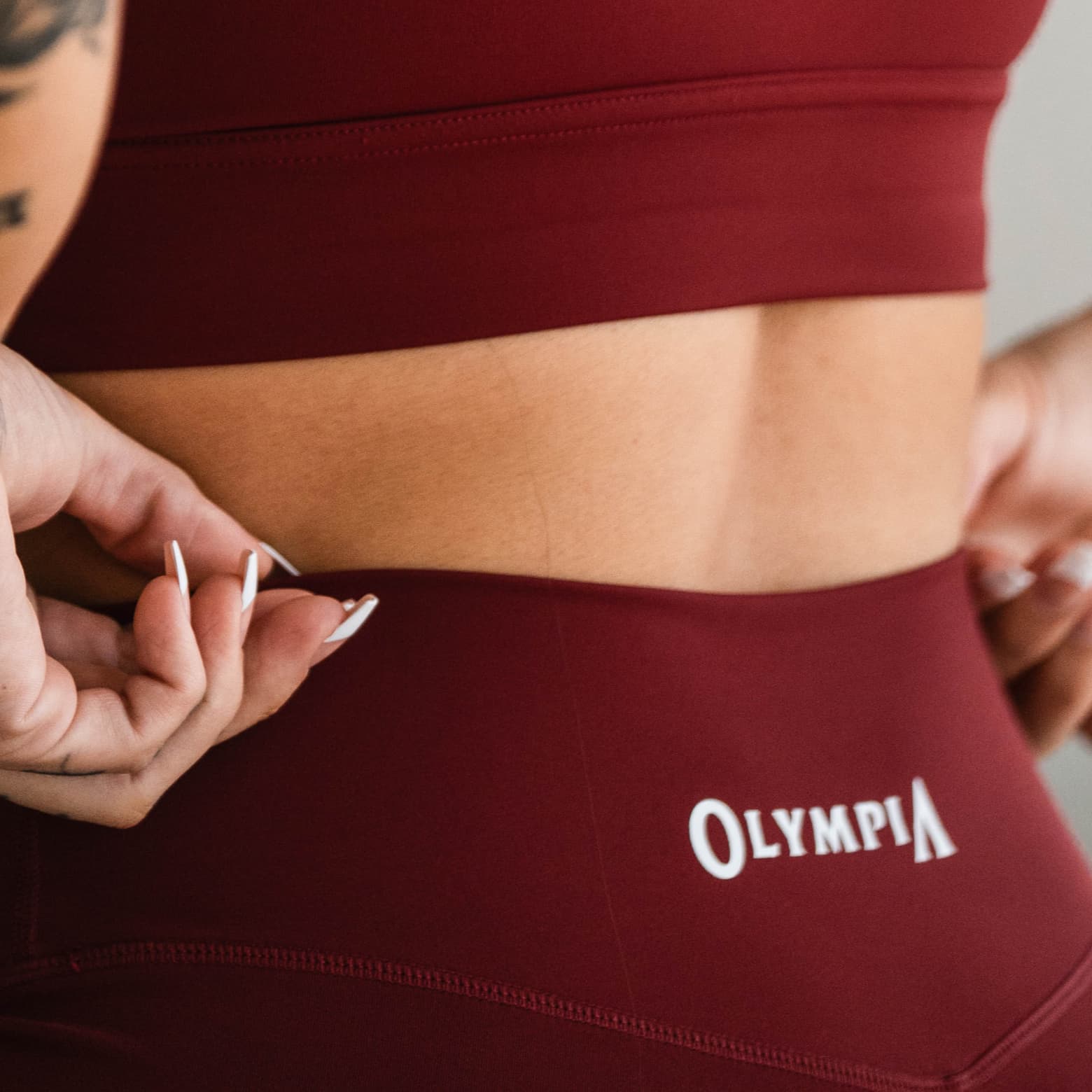Close-up of the Olympia 4" Training Shorts waistband, highlighting the Olympia logo print.