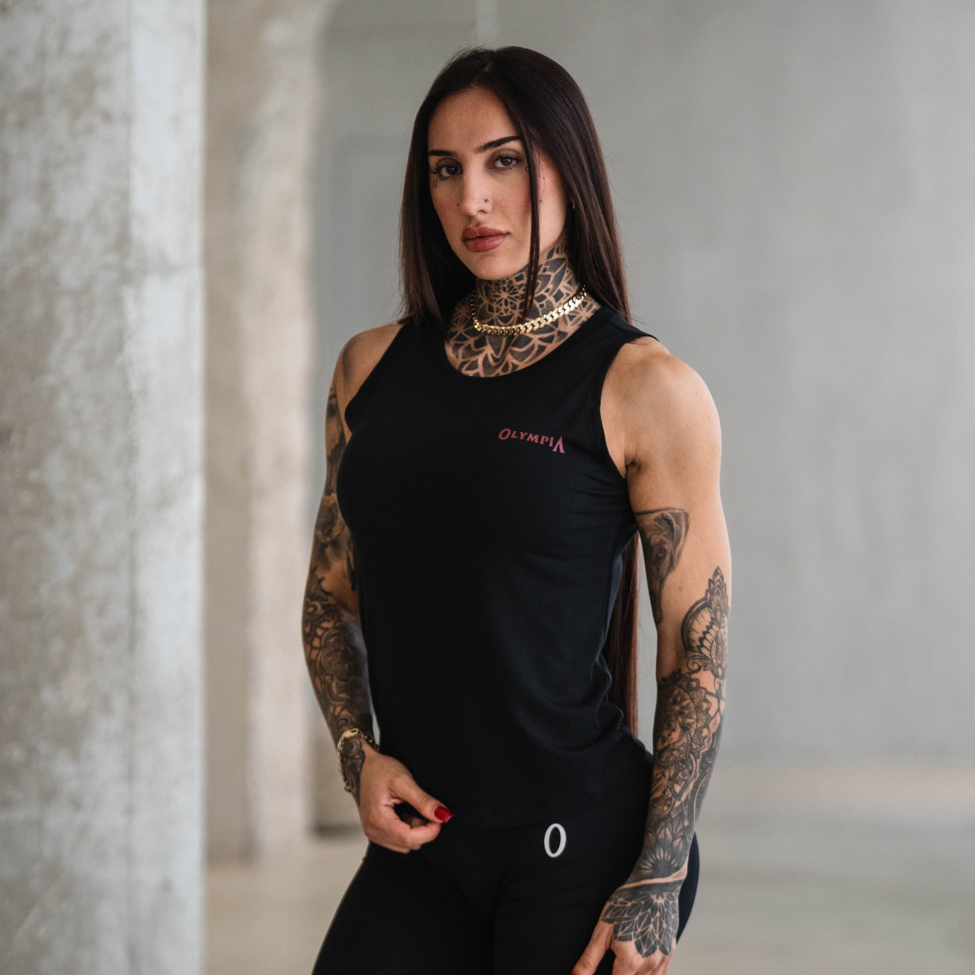 Model wearing Olympia Full Length Training Tank, angled front view.