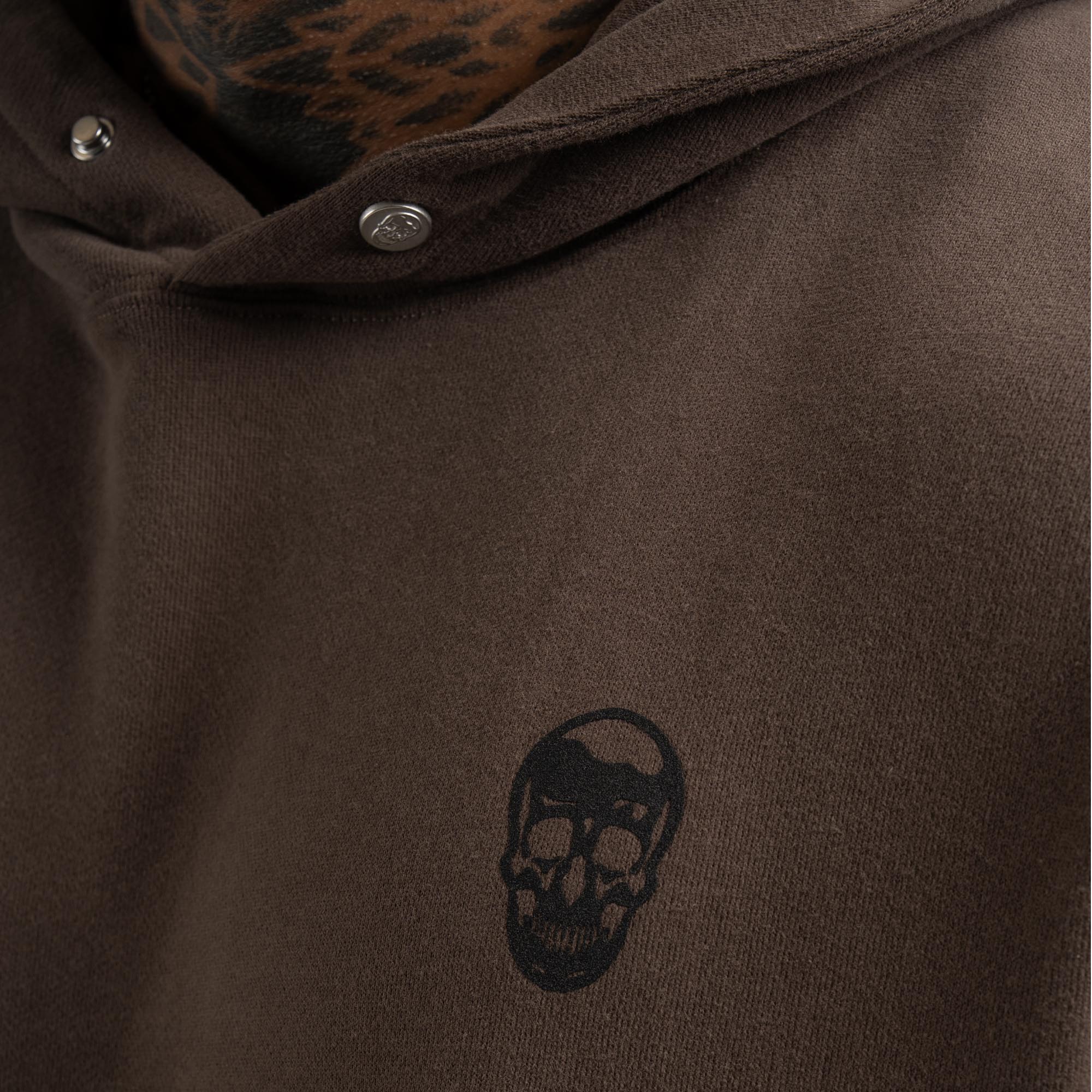 athlete wearing toffee heavyweight hoodie close up shot of logo