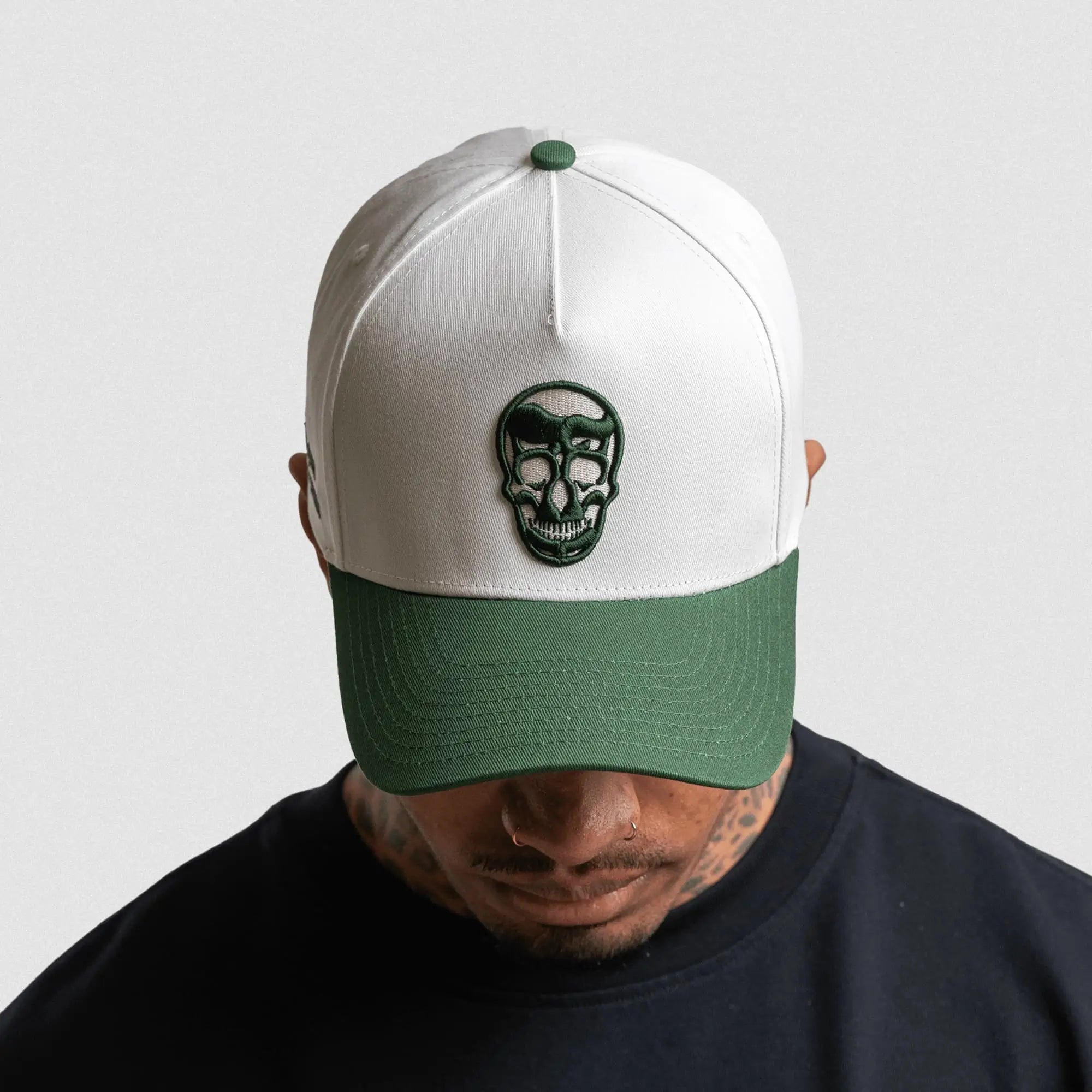 5 panel skull hat white green front on athlete gray background