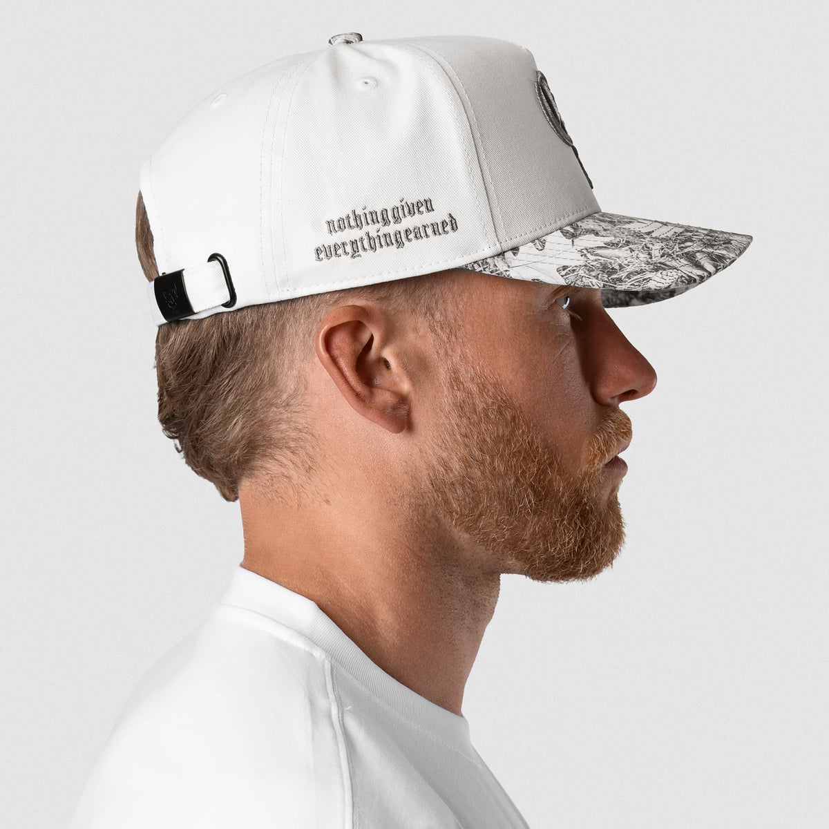 Male model wearing the 5-Panel Initial Hat - White Camo left side view