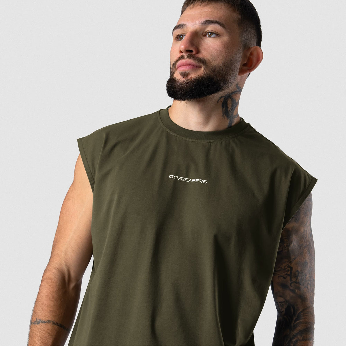 Male model wearing the Axis Cap Sleeve Tank - OD Green angled view