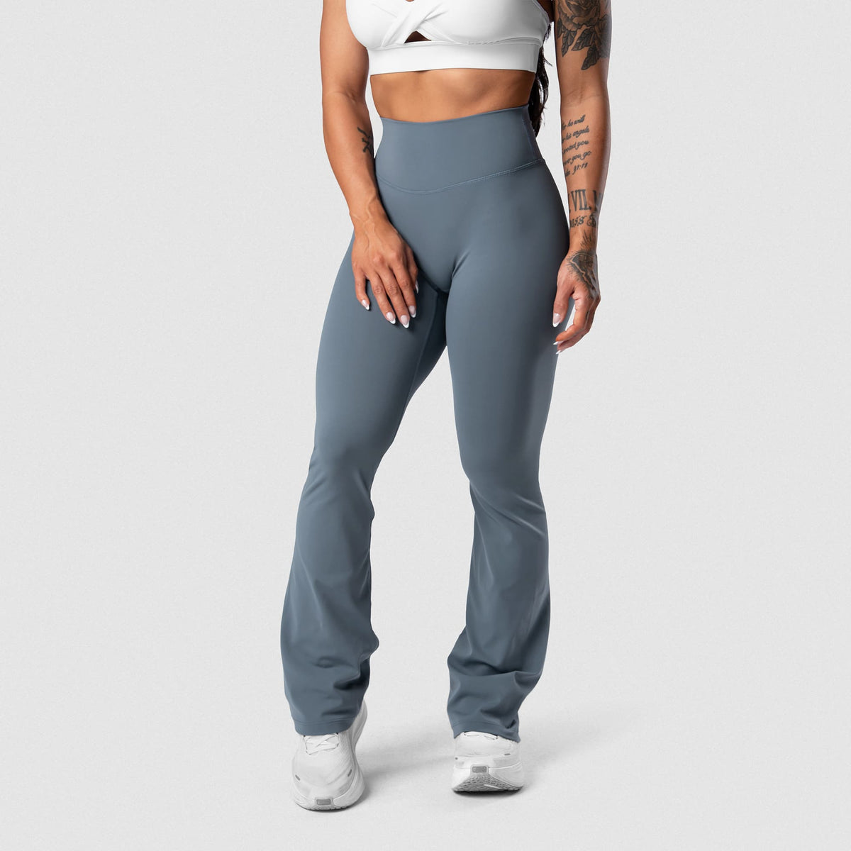 Female model wearing the Axis Flare Leggings - Lake front view