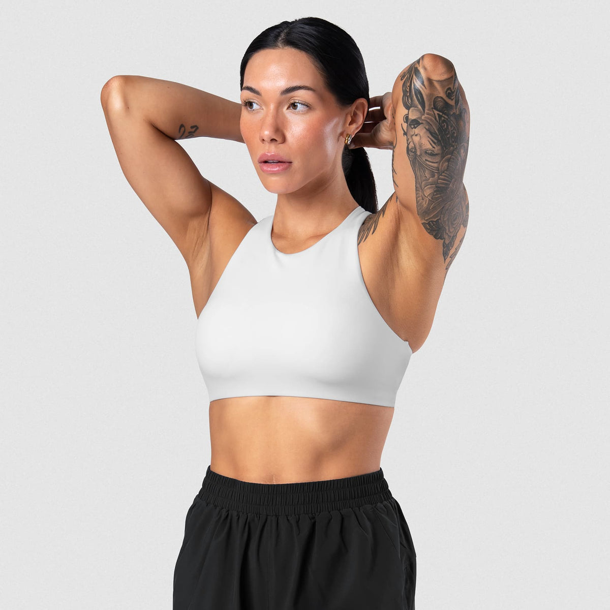 Female model wearing the Axis High Neck Bra - White front view
