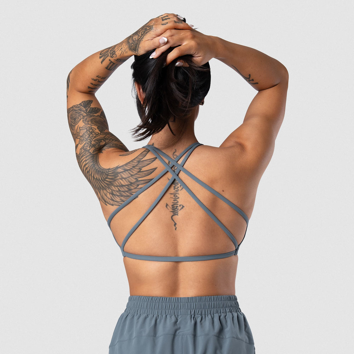 Female model wearing the Axis Open Back Bra - Lake open-back view