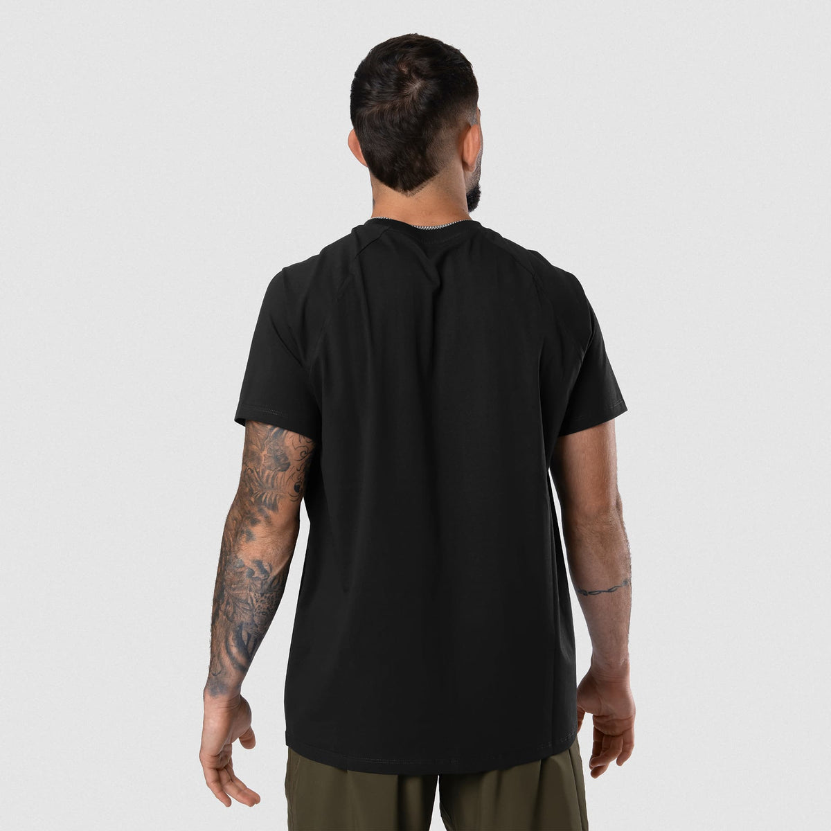 Male model wearing the Axis Raglan Tee - Black/White back view
