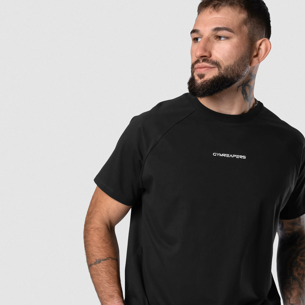 Male model wearing the Axis Raglan Tee - Black/White angled view