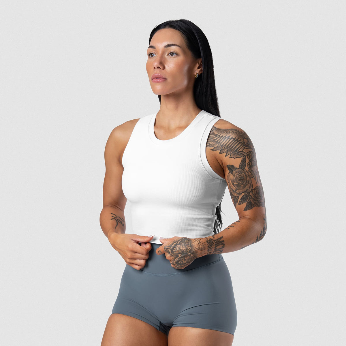 Female model wearing the Axis Support Tank - White front view