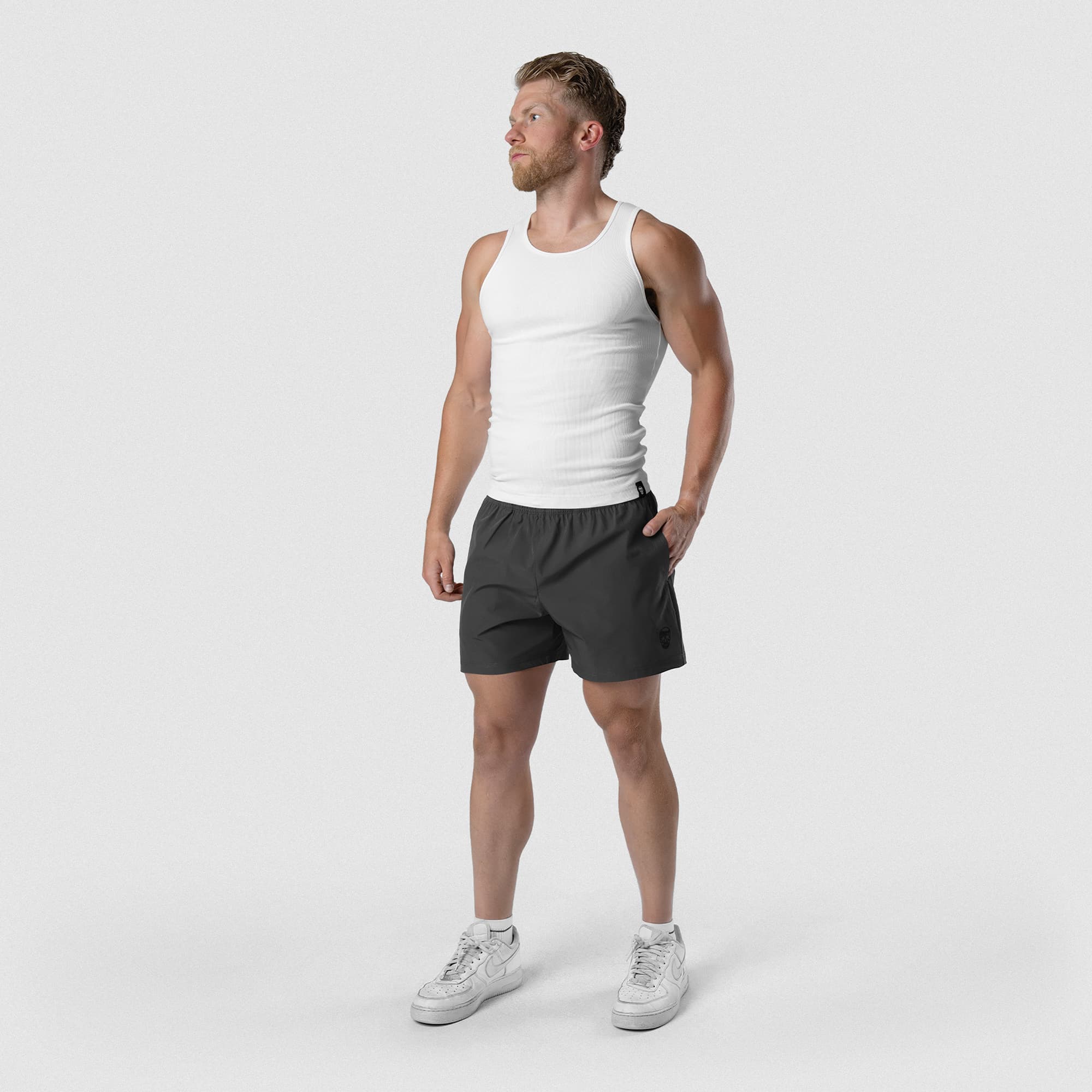 Model wearing Men's Conquer 5 Inch Shorts - Dark Gray