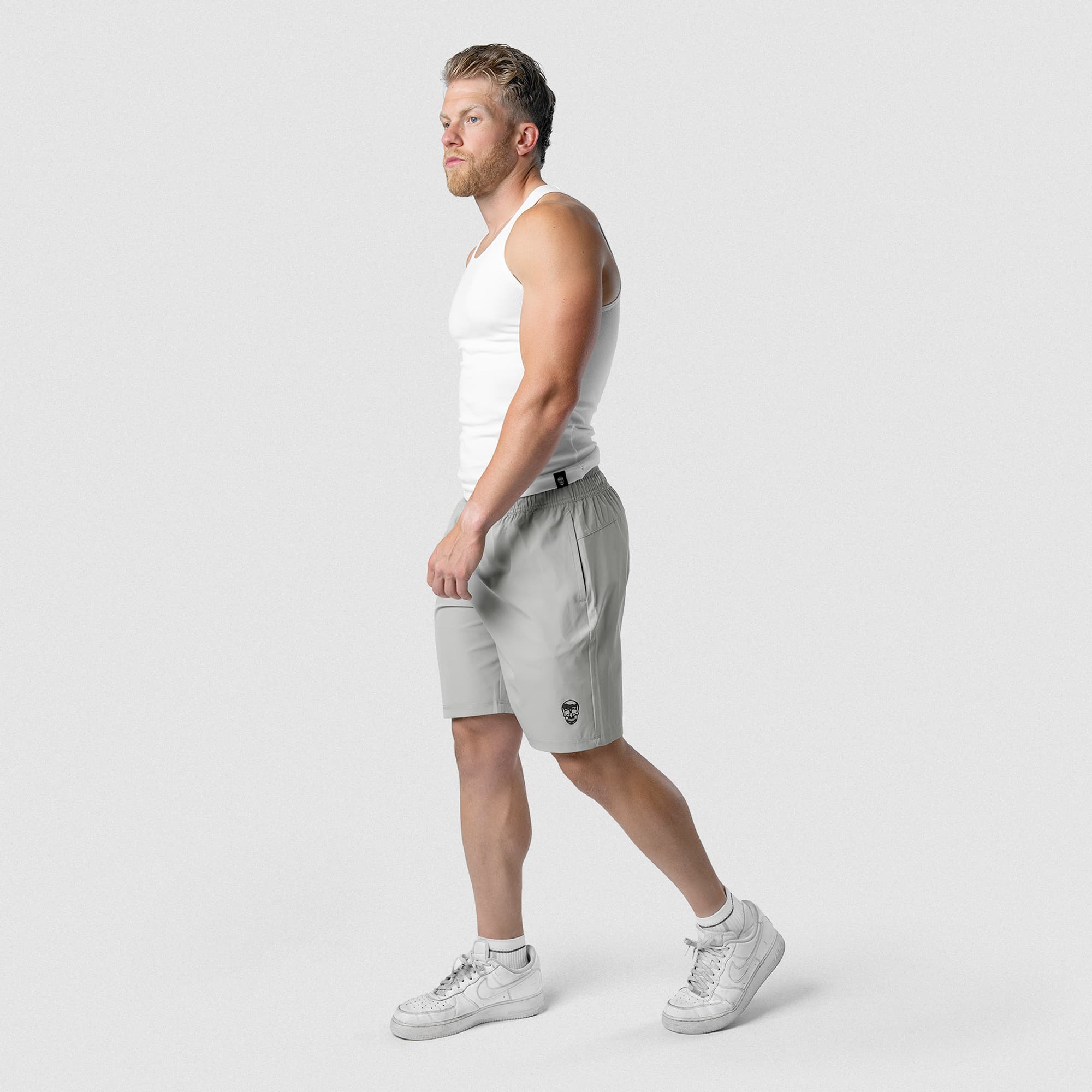 Model wearing Men's Conquer 9 Inch Shorts - Gray