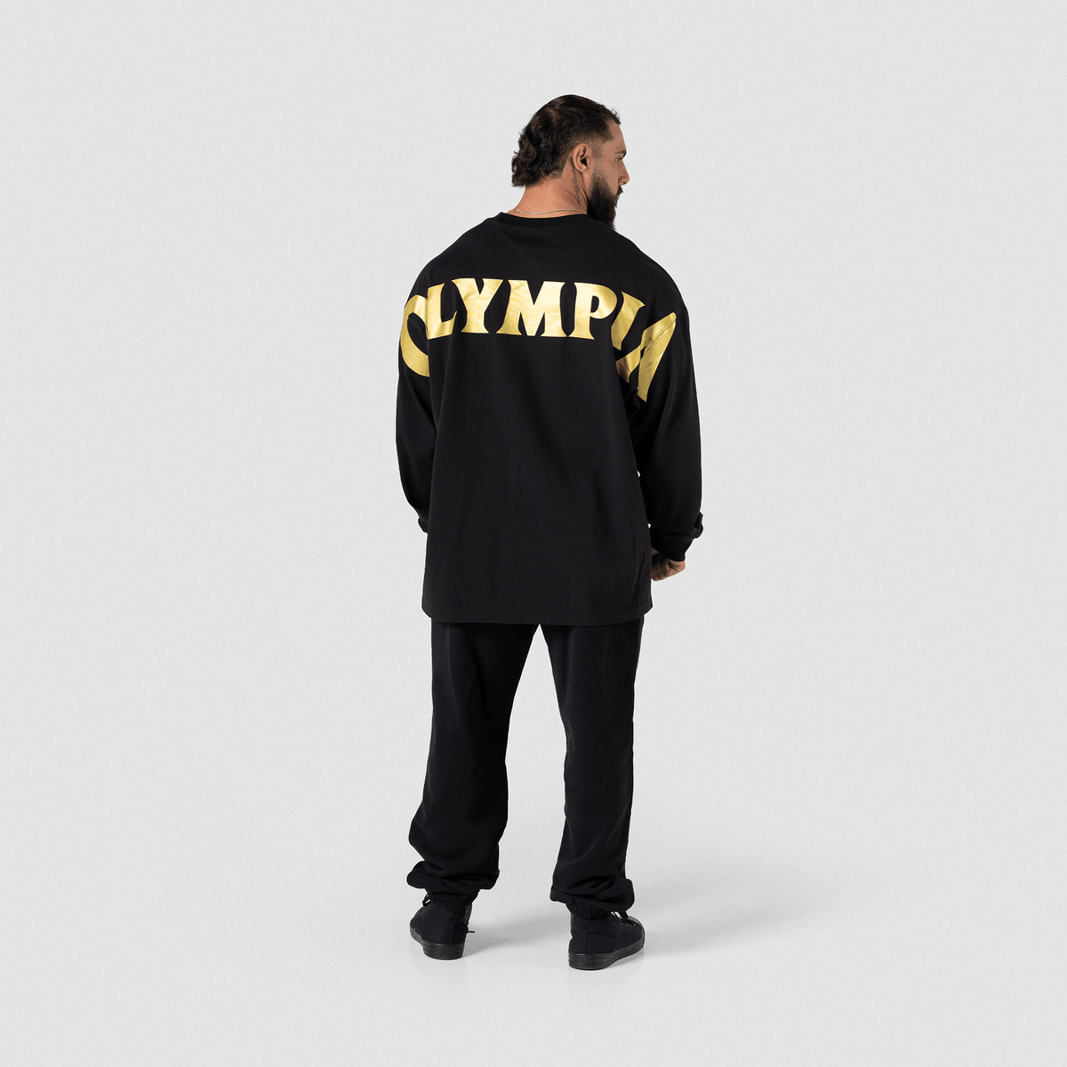 Close-up of gold "OLYMPIA" text on black fabric back