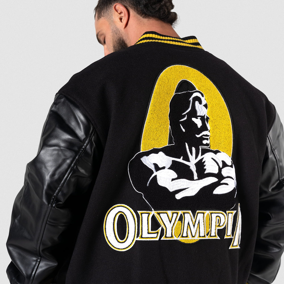 Olympia Champions Gold Varsity Jacket in Black – Back Logo Close-Up