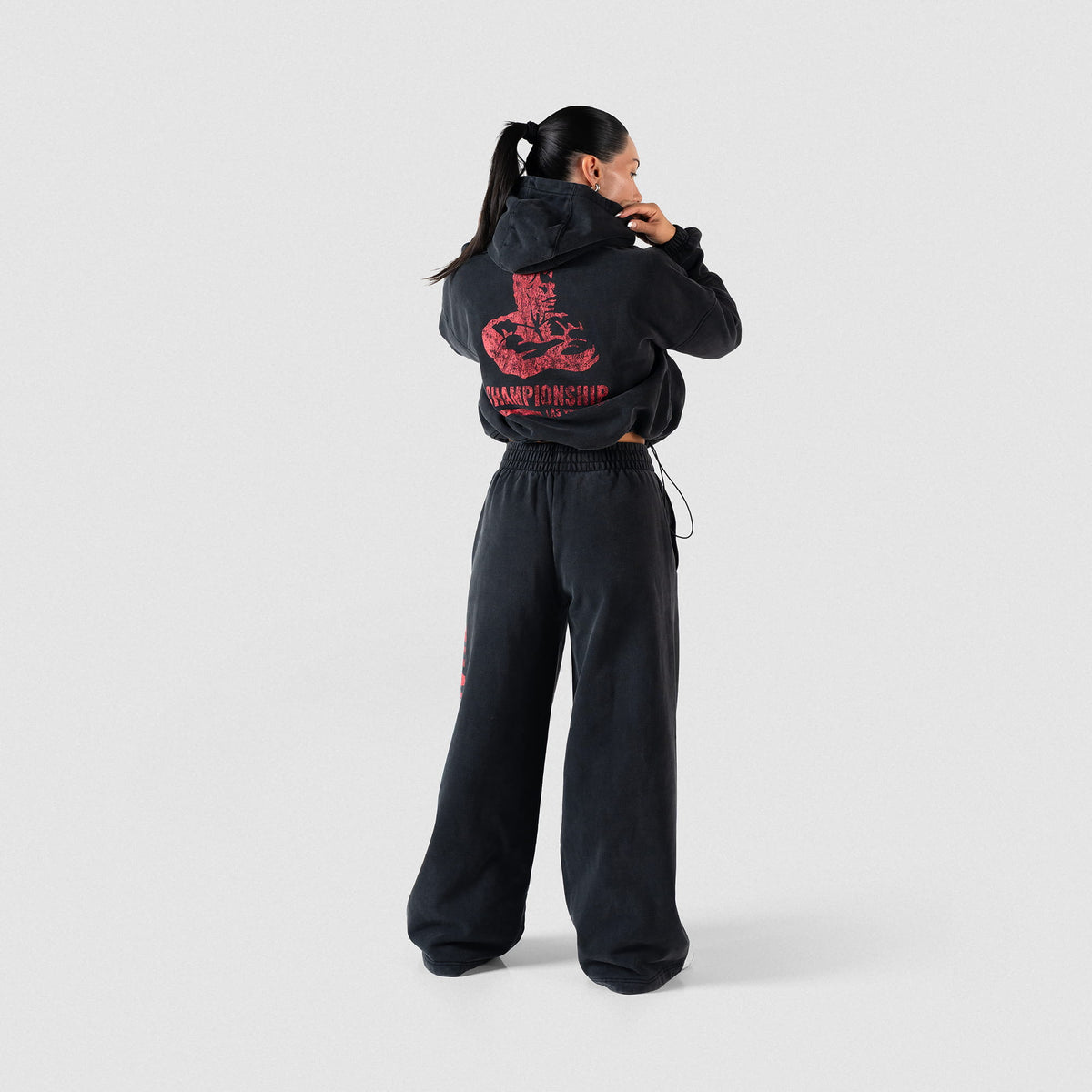 Championship Crop Hoodie | Full body, back view of model wearing black hoodie and matching joggers