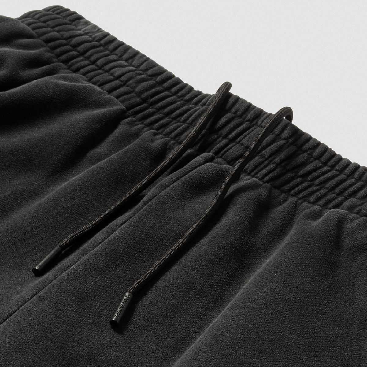 Close up of adjustable drawstrings on the black Championship Straight-Leg Jogger