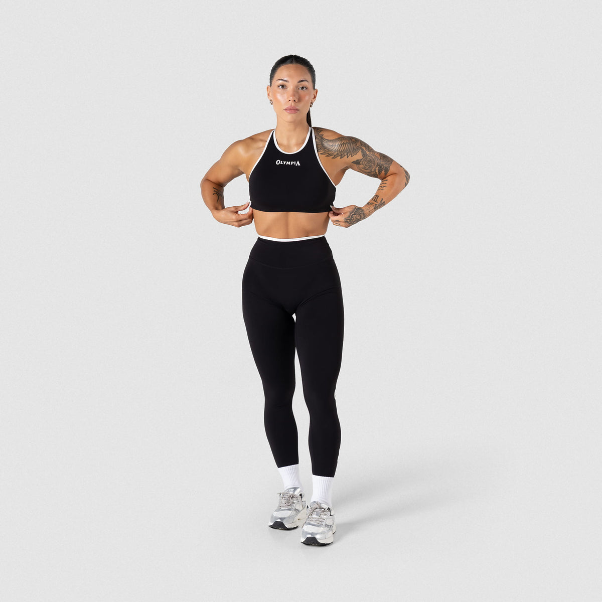 Full view of model wearing the Olympia High Neck Bra and matching leggings that have Black/White contrasting 