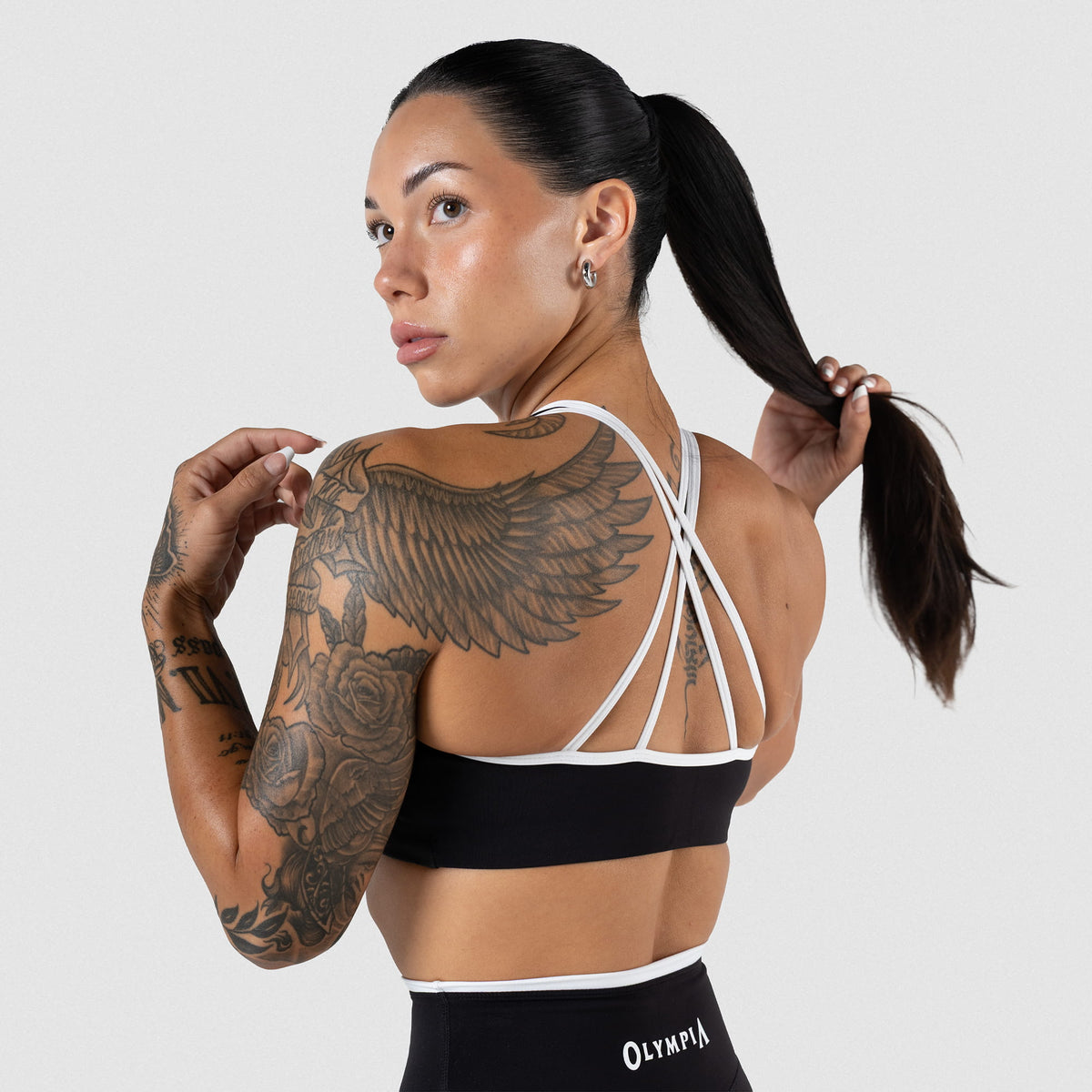 Back of the Olympia High Neck Bra with Black/White contrast details, including white straps and black bra body