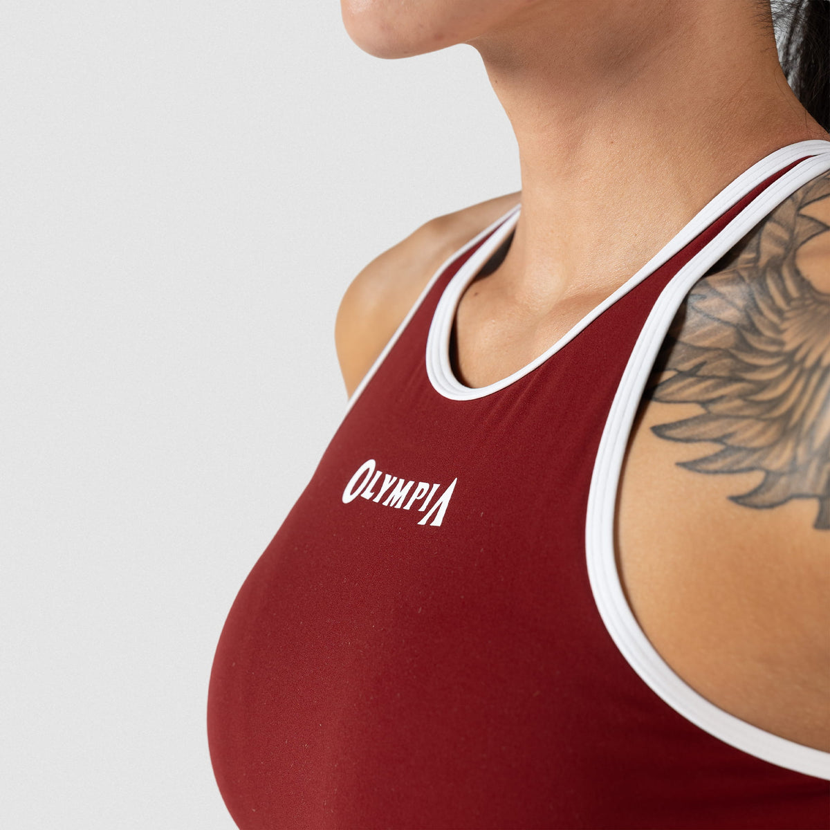 Side view of the women's high neck olympia sports bra in red and white