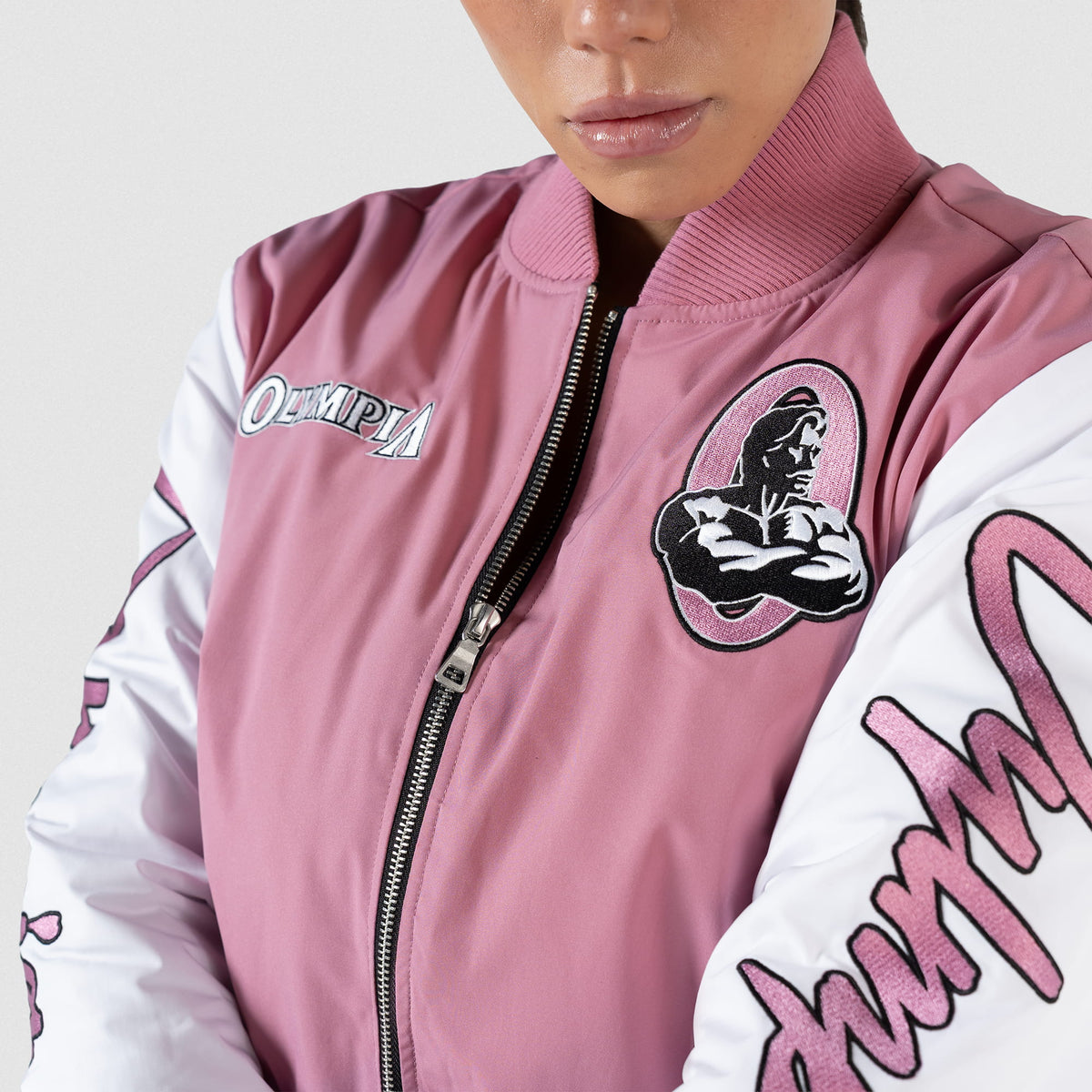 Rose Division Crop Bomber Jacket | Front zipper detail of the jacket on the model and it half zipped