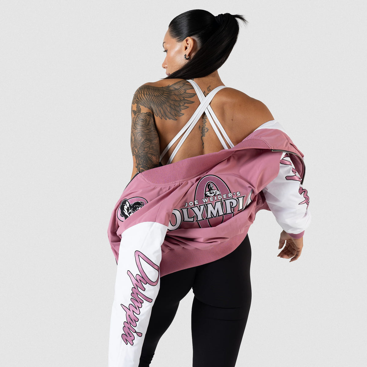 Rose Division Crop Bomber Jacket | Back view of model while taking the jacket off