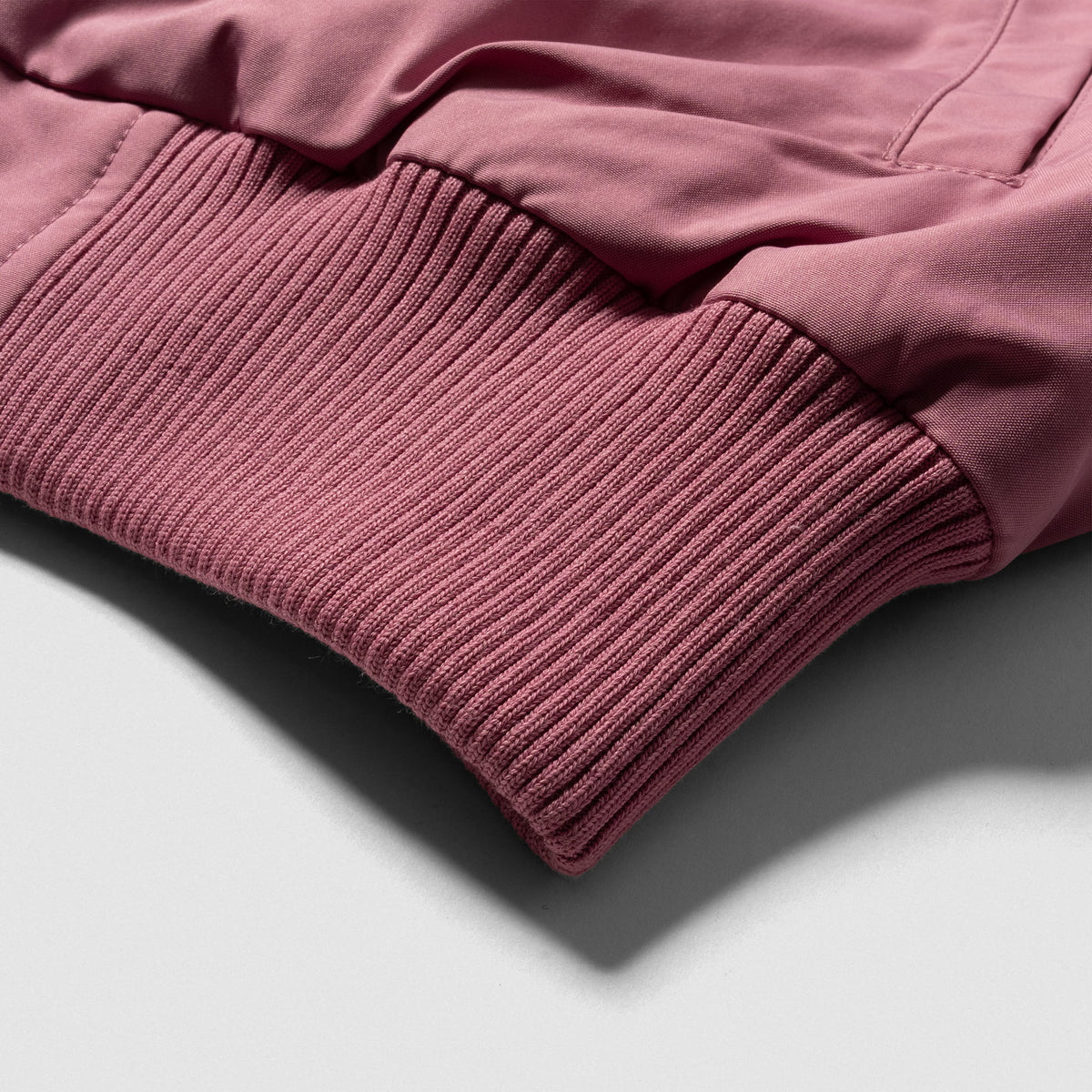 Rose Division Crop Bomber Jacket | Bottom cuff feature and detailing in pink