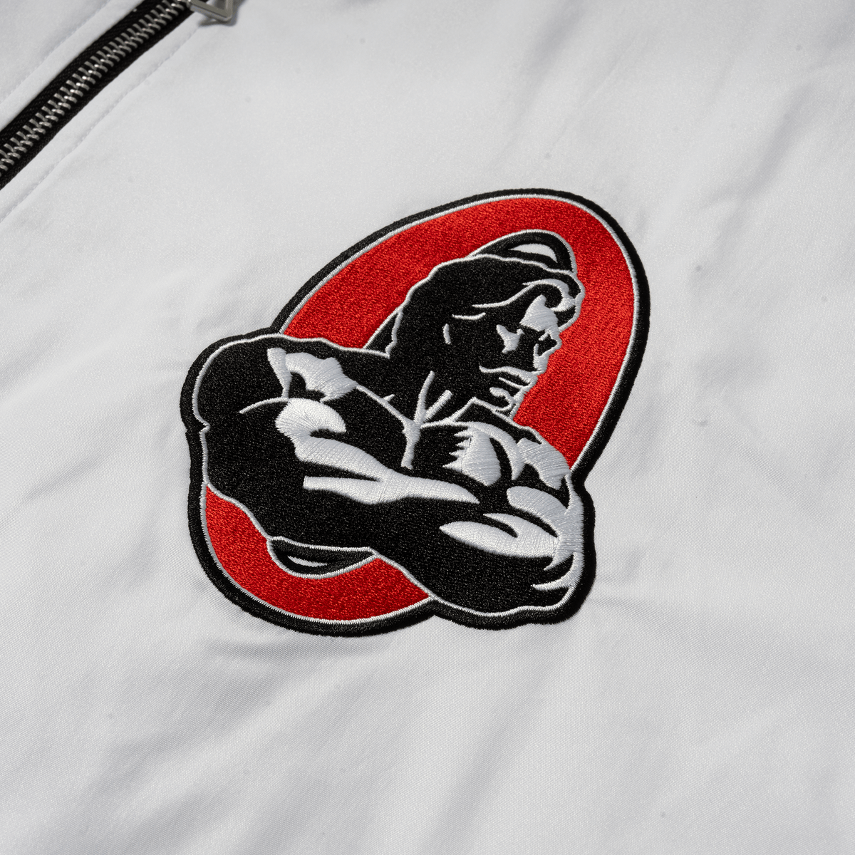 5. Olympia Signature Bomber Jacket in White – Bulldog Patch Detail
