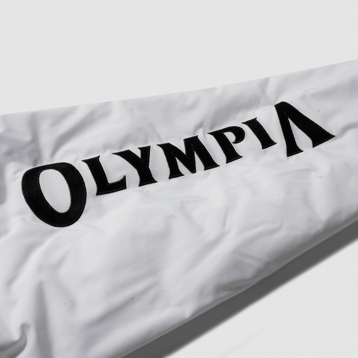 8. Olympia Signature Bomber Jacket in White – Sleeve Logo Detail