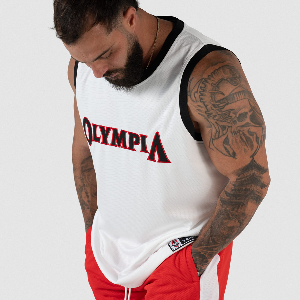 Signature Jersey | male model looking down while wearing the white basketball inspired jersey with 