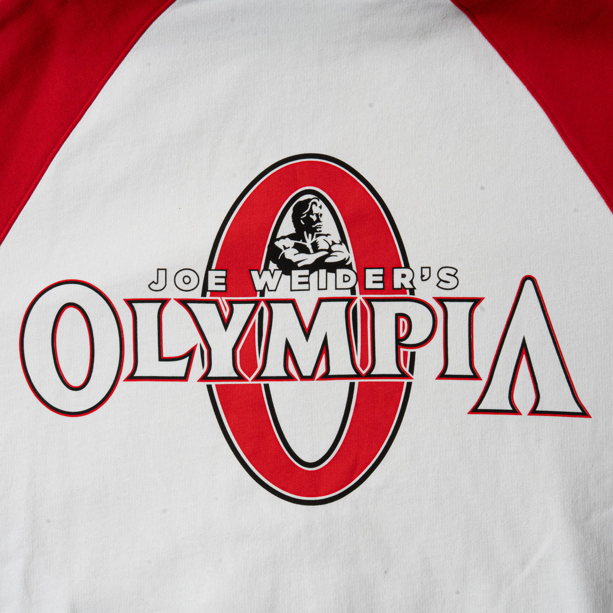 Signature Zip-Up Hoodie | large back graphic logo of red Olympia "O" and white text overlaying it that says "Joe Weider's Olympia"