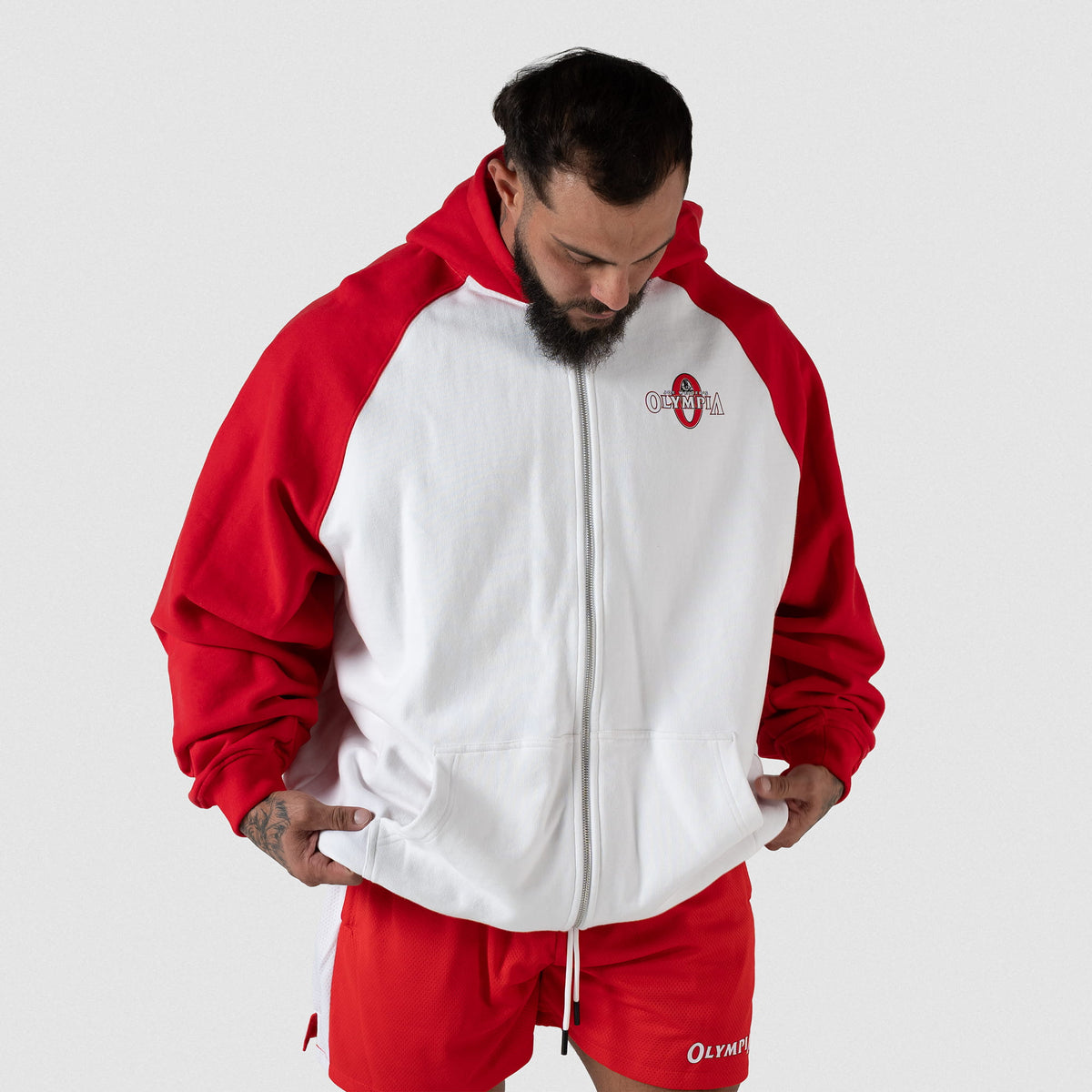 Signature Zip-Up Hoodie | Male model wearing the white full zip hoodie with red sleeves, fully zipped